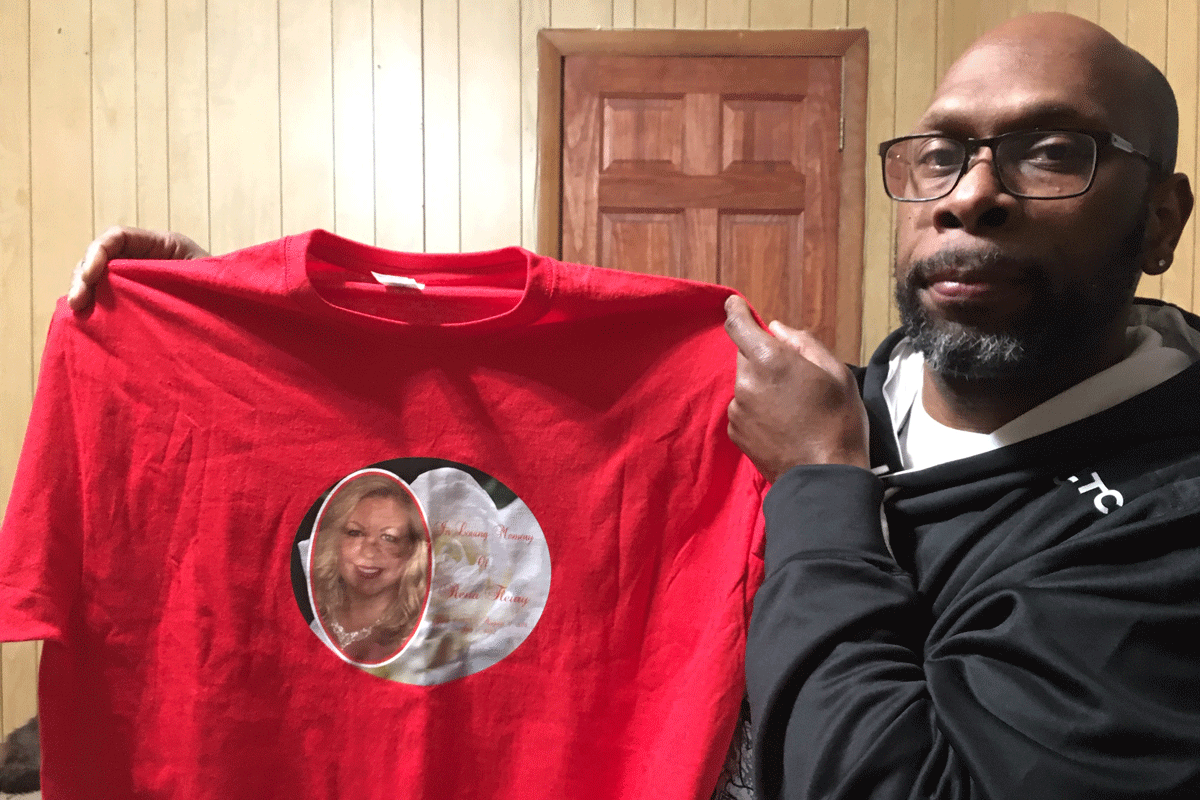 Kevin White held up a t-shirt made by a family member in memory of Rena Fleury.