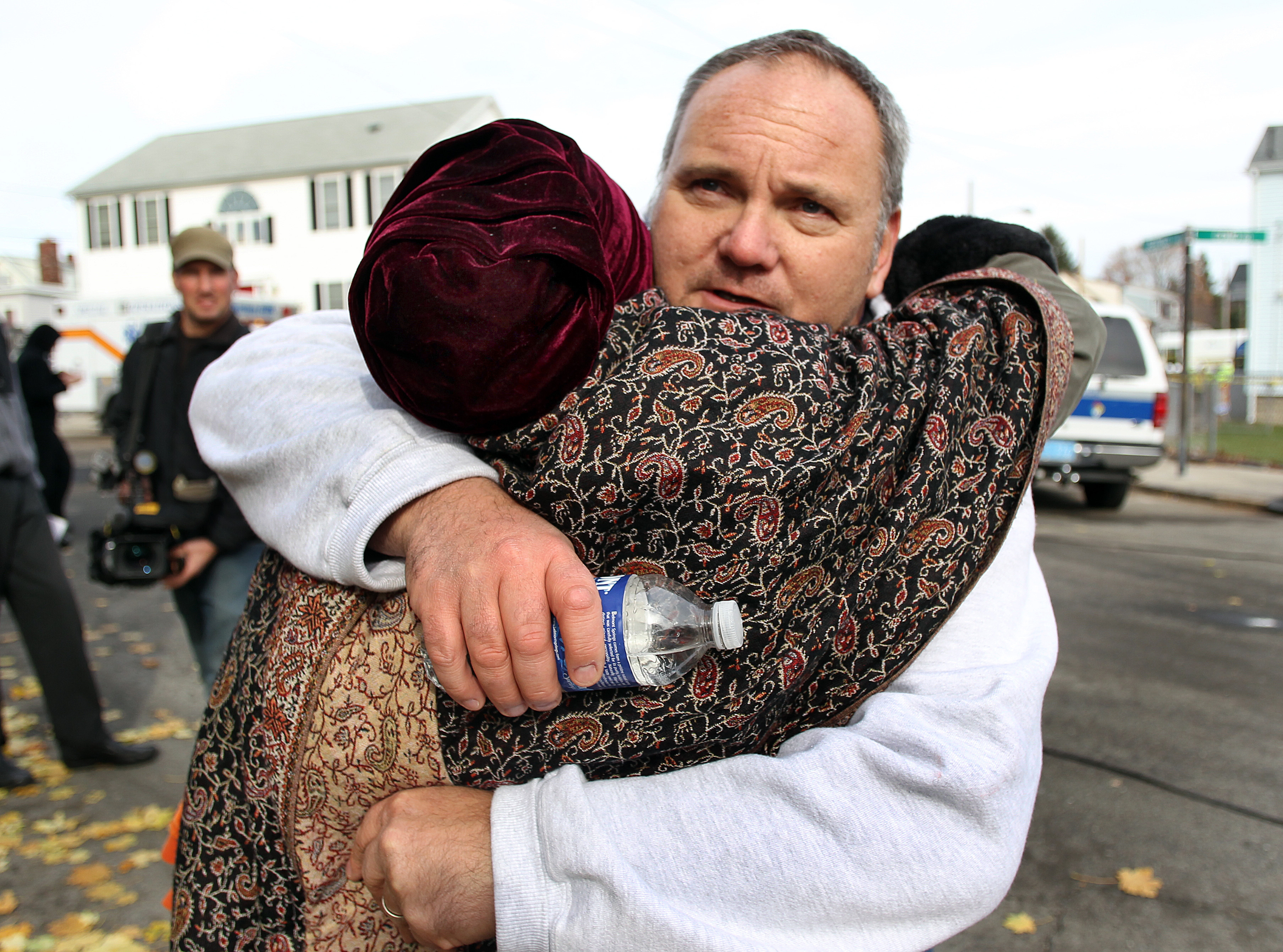 After a massive explosion blew up a house in Hyde Park’s Readville section in 2010, Obie Bah huged Michael Burns (right), whose home exploded.