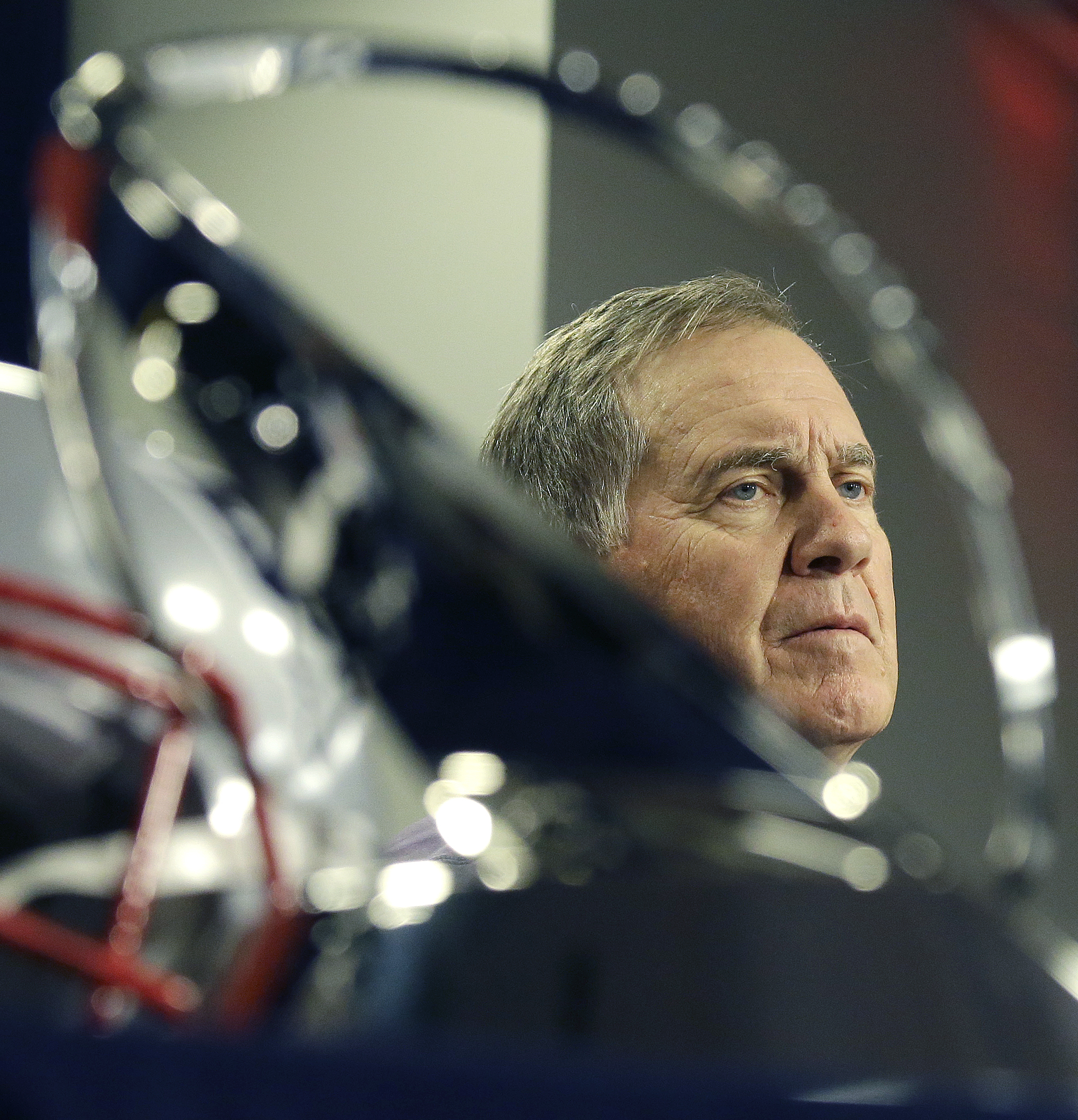 Bill Belichick is framed by the AFC championship trophy during his news conference Wednesday.