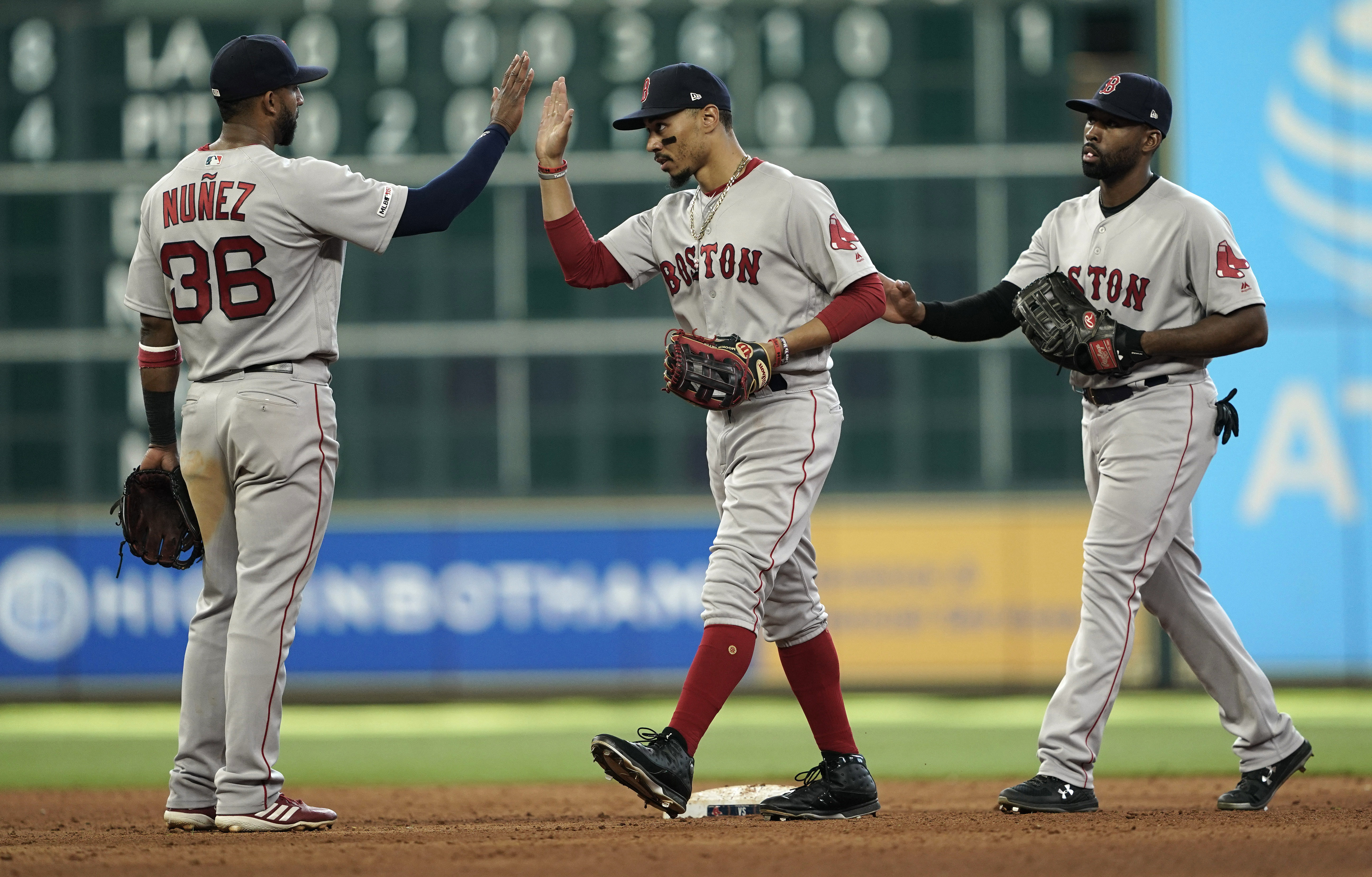 Eduardo Nunez, Mookie Betts (middle) and Jackie Bradley Jr. celebrate after the Red Sox defeated the Astros in the series finale on Sunday.