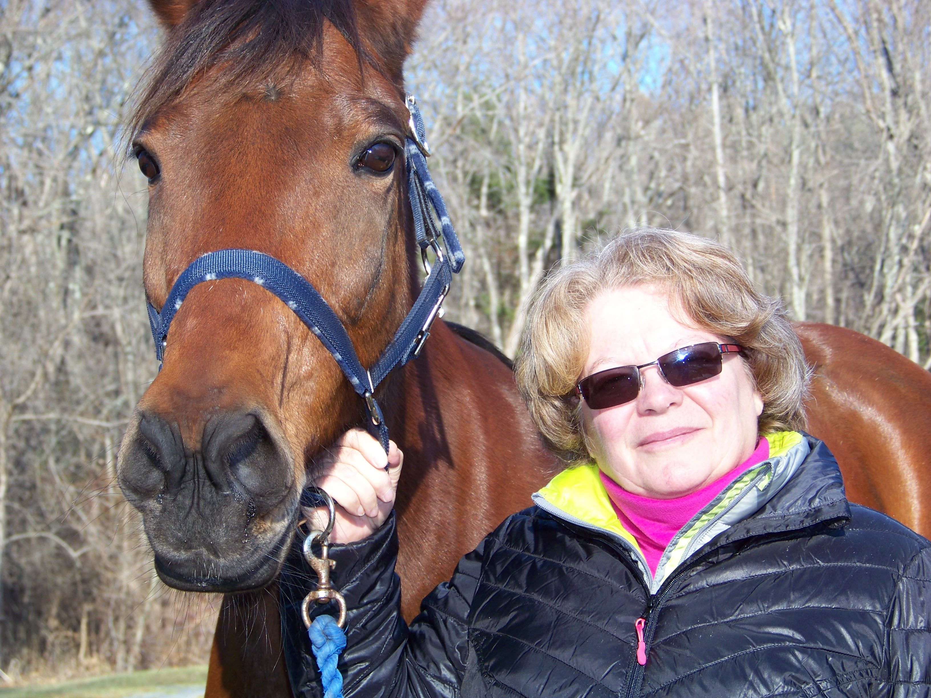 Caroline Matterson and her standard bred horse, Clint, in her backyard.