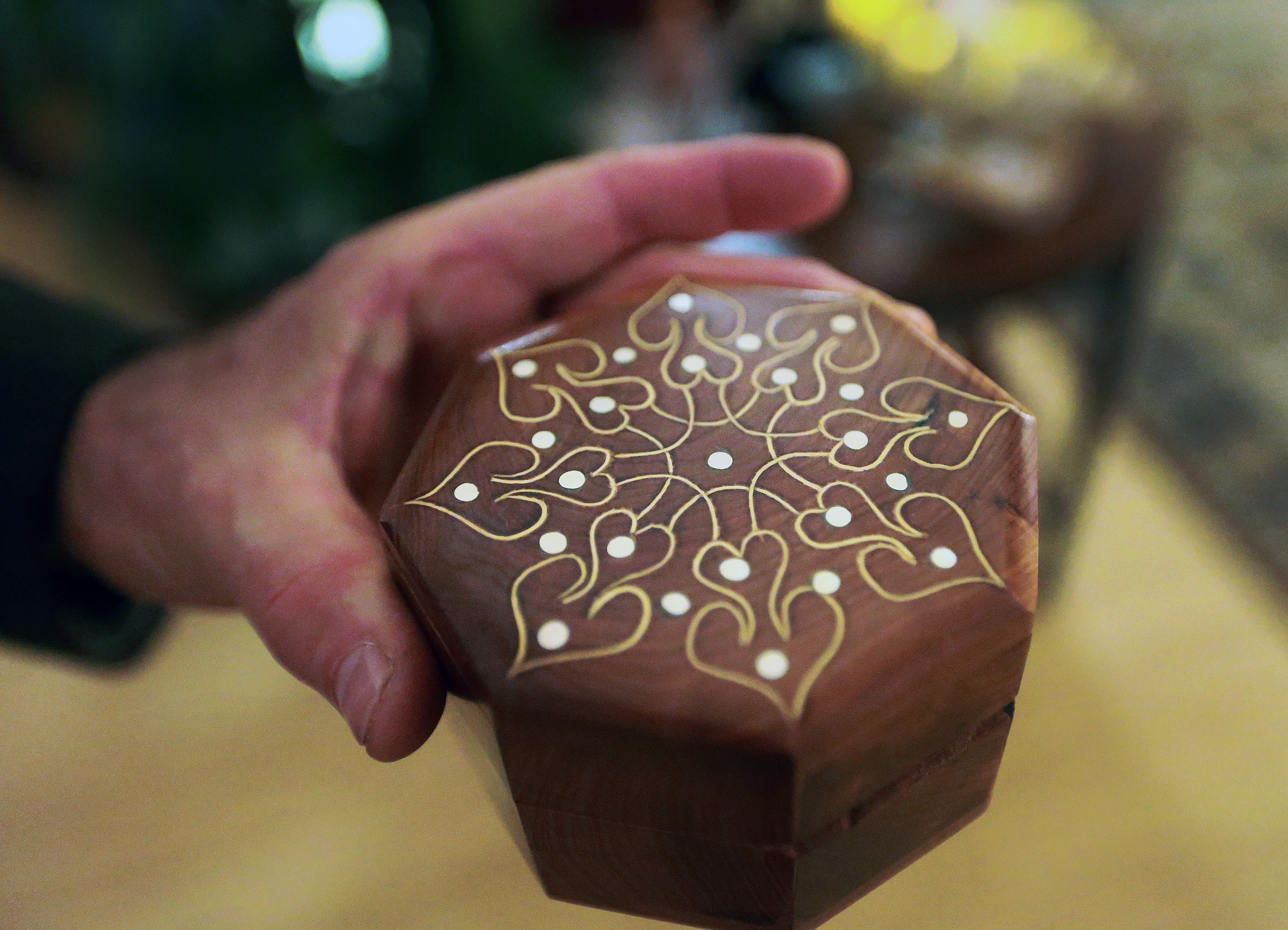 Paul Swope held an item that has some small mother of pearl on top of it in his store "A World Apart.”