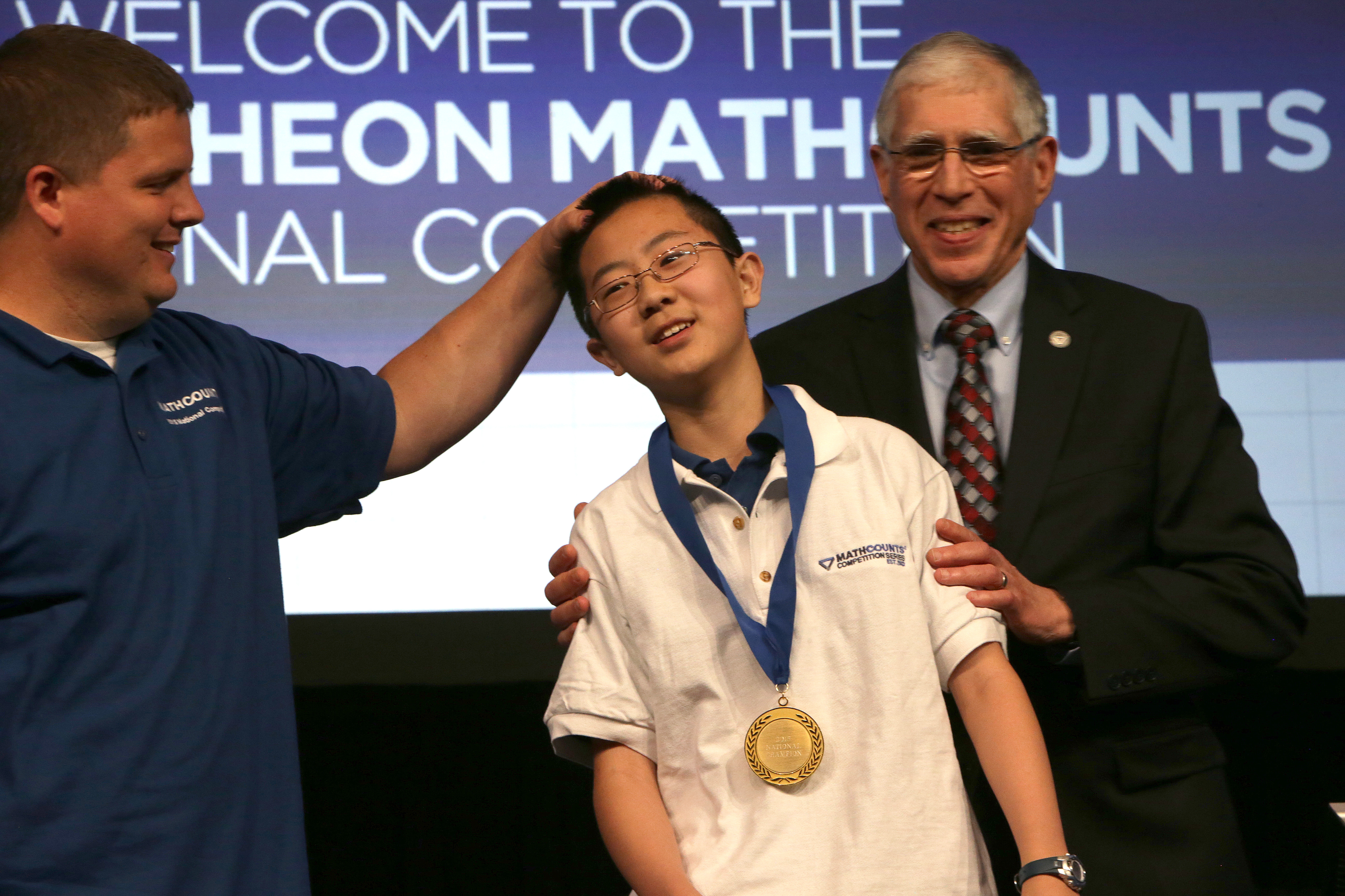 National Champion Kevin Liu, an eighth-grader from Carmel, Ind., with his team coach Trent Tormoehlen.