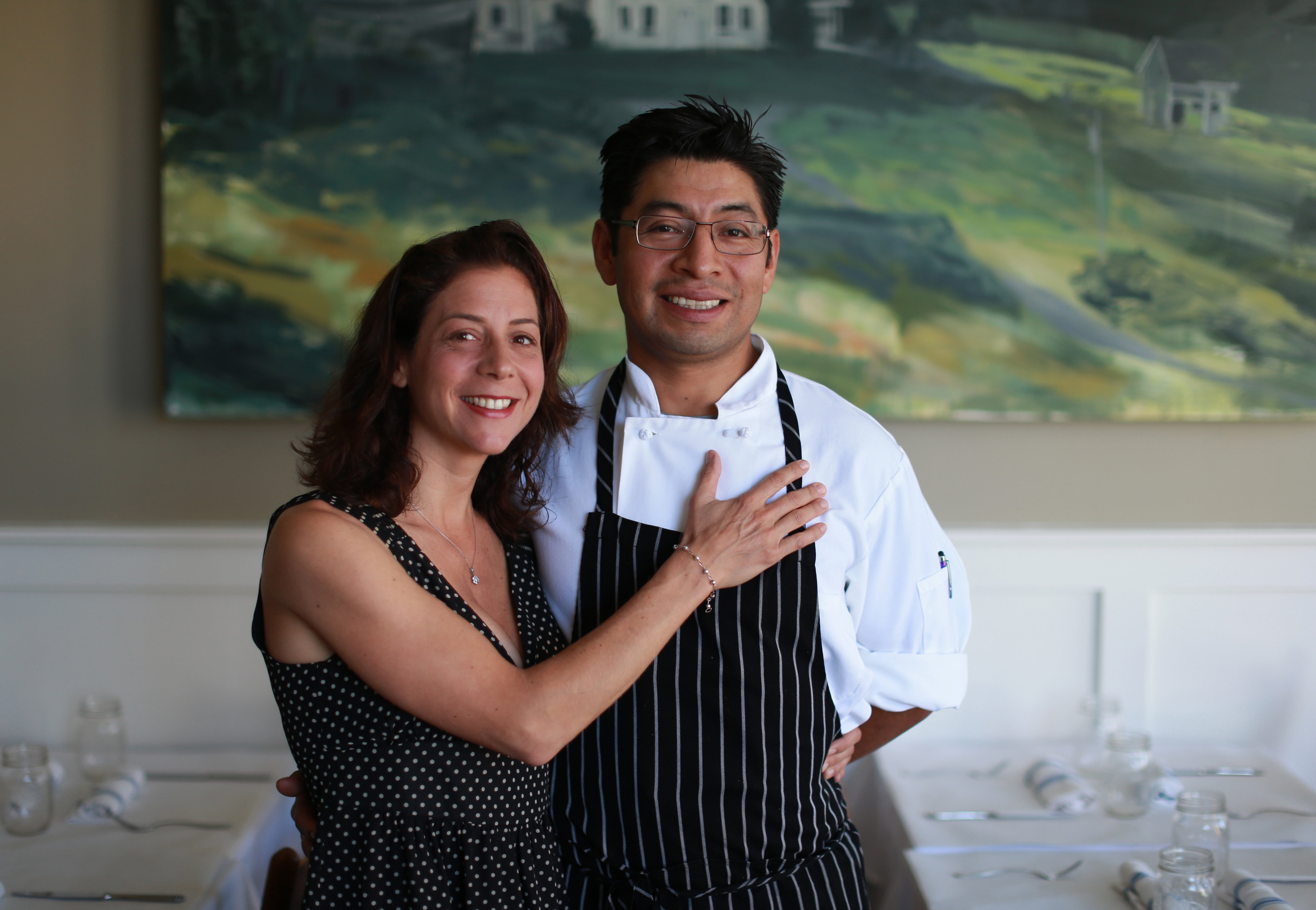 THE FARMHOUSE: Dora Tavel-Sanchez Luz and her husband, Gabriel Sanchez Luz, in their Needham restaurant, which opened in March, fueled by a Kickstarter campaign that helped them buy the rustic door and chairs for the place.