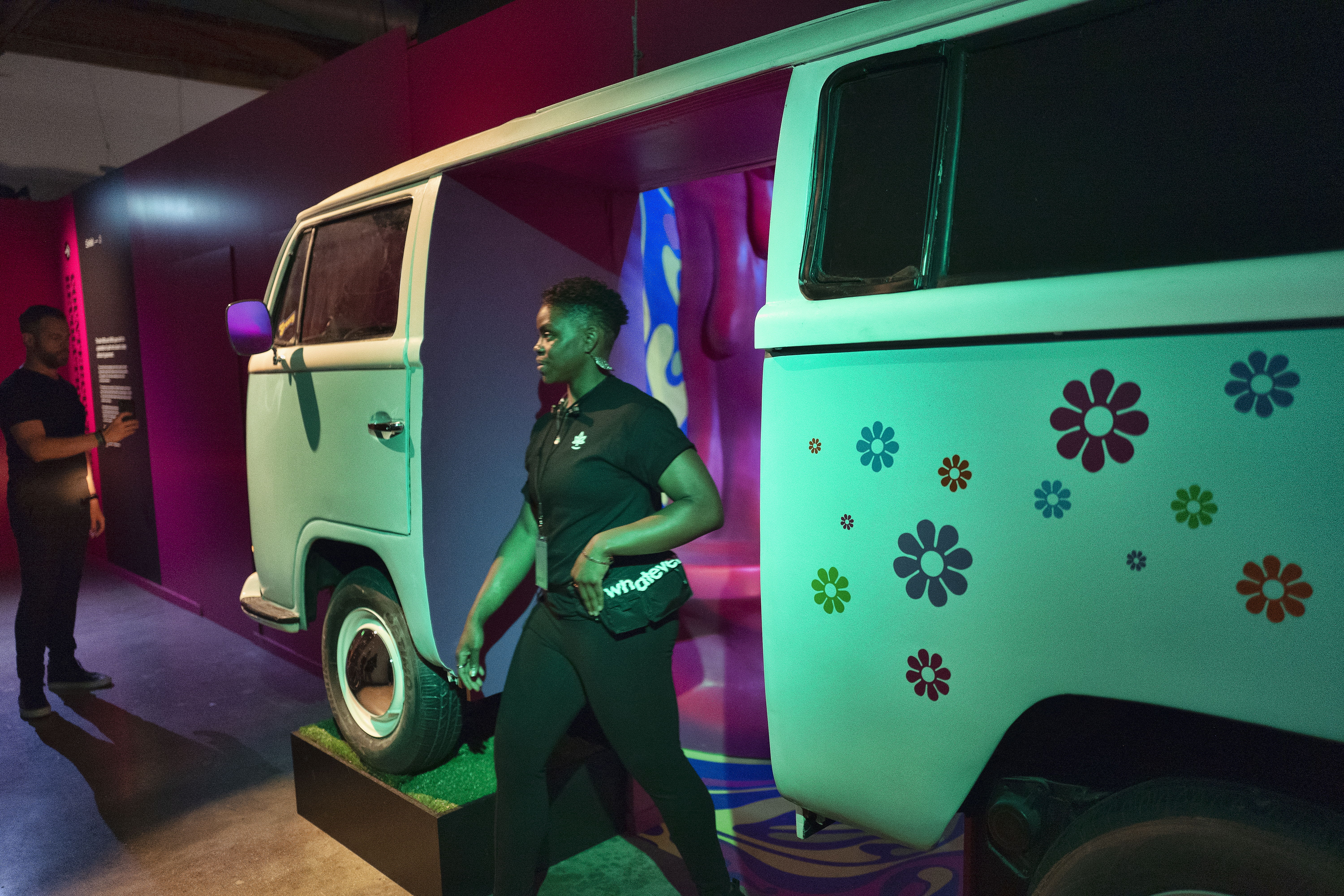 A gallery goer walks through a 1960's VW bus gallery into an interactive space.