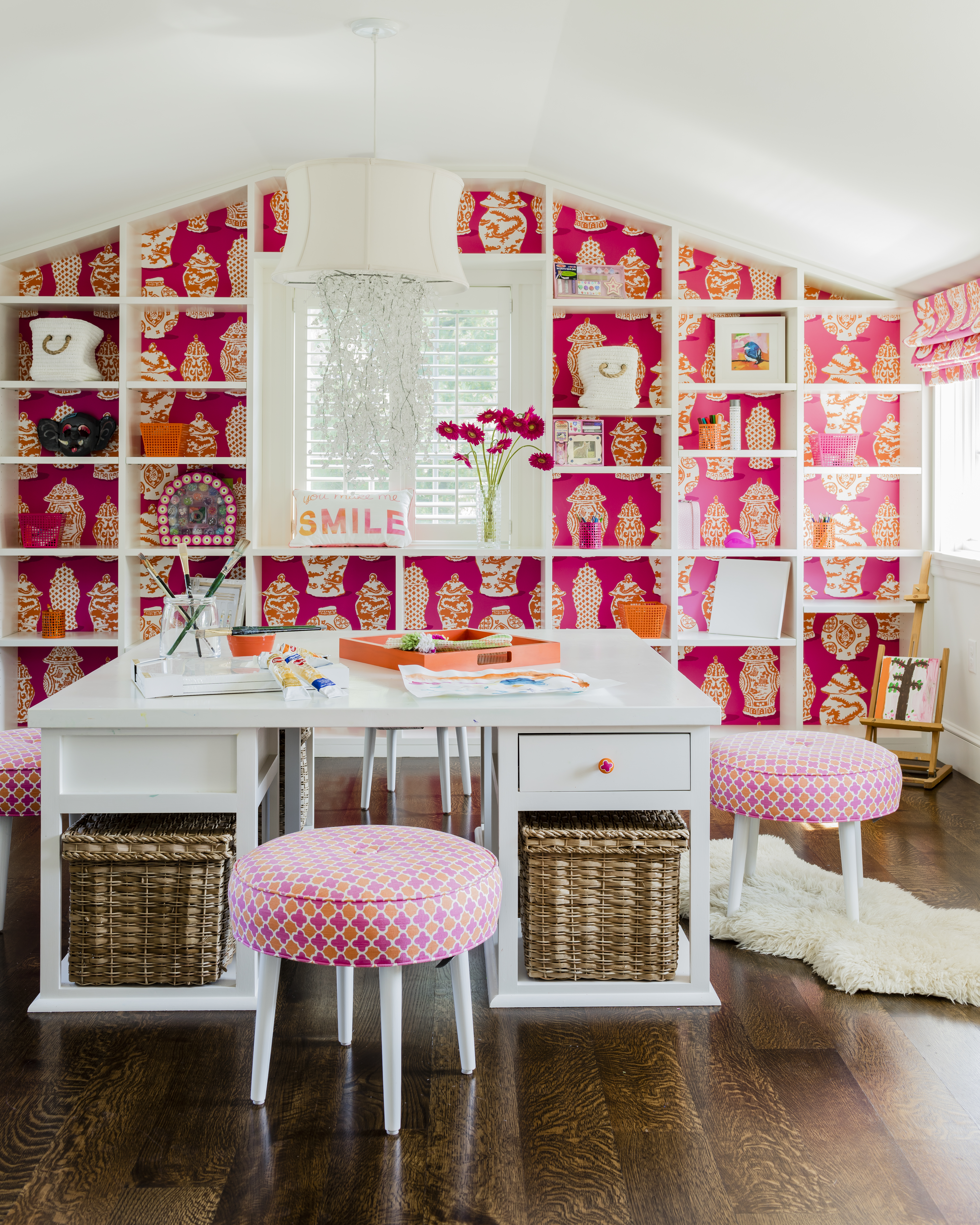 The third-floor art room has a lively pink and orange color scheme and amazing natural light, says Ward. The couple’s four daughters work on art projects here and display their creations.