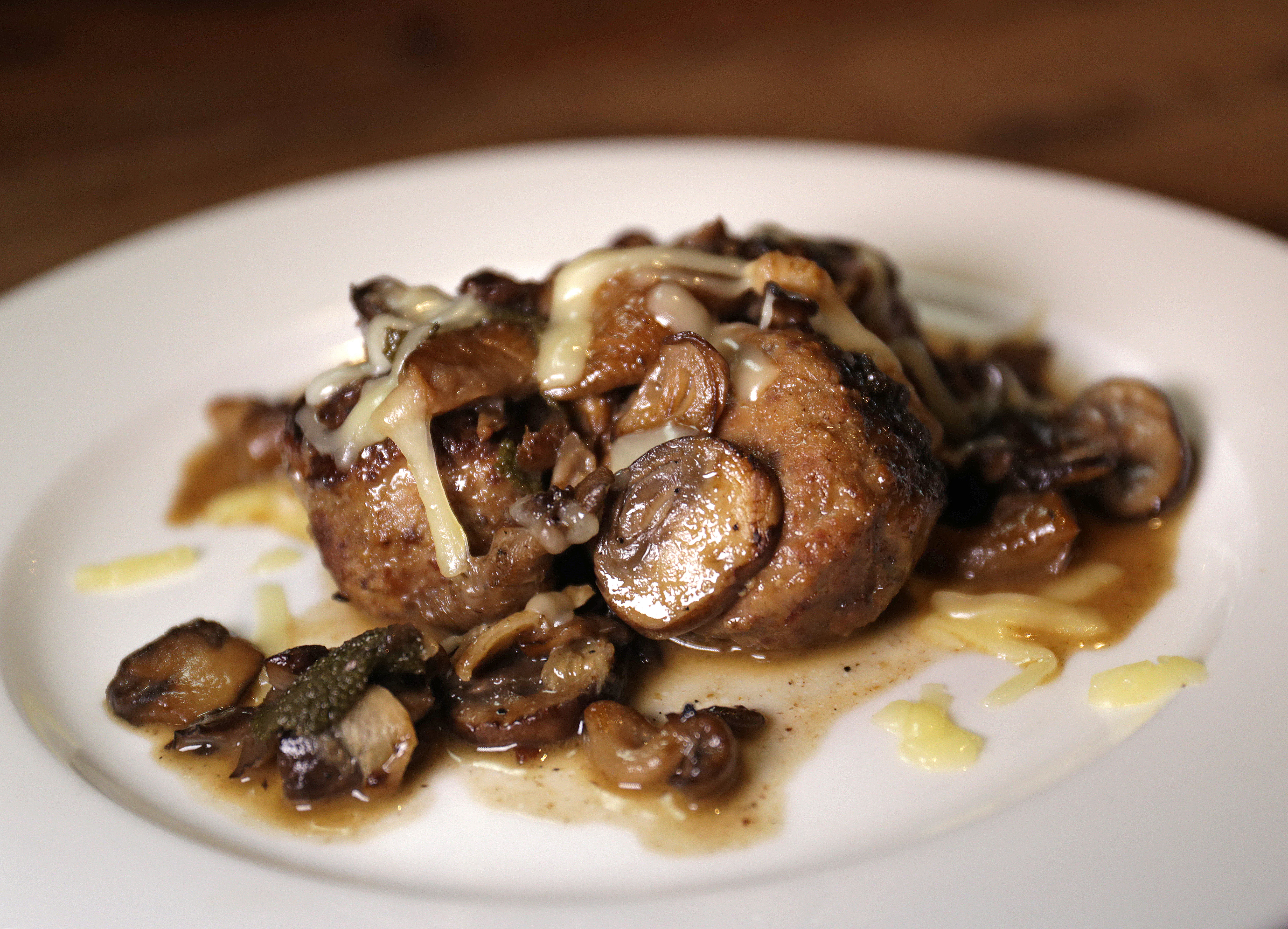 Meatballs topped with braised mushrooms and shredded Fontina.