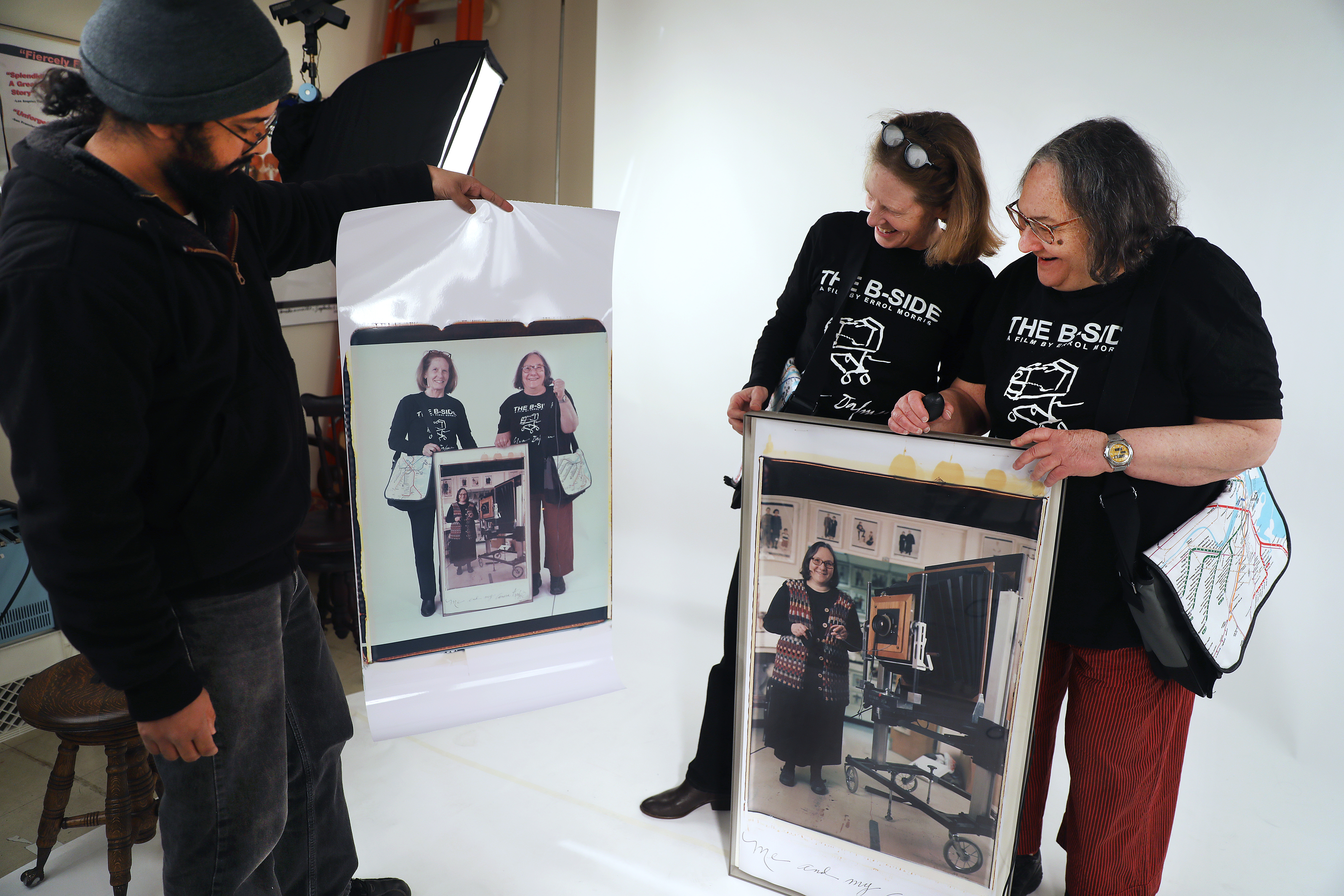 Nafis Azad, left, held up a photo just taken of Dorfman, right, and Margot Kempers.
