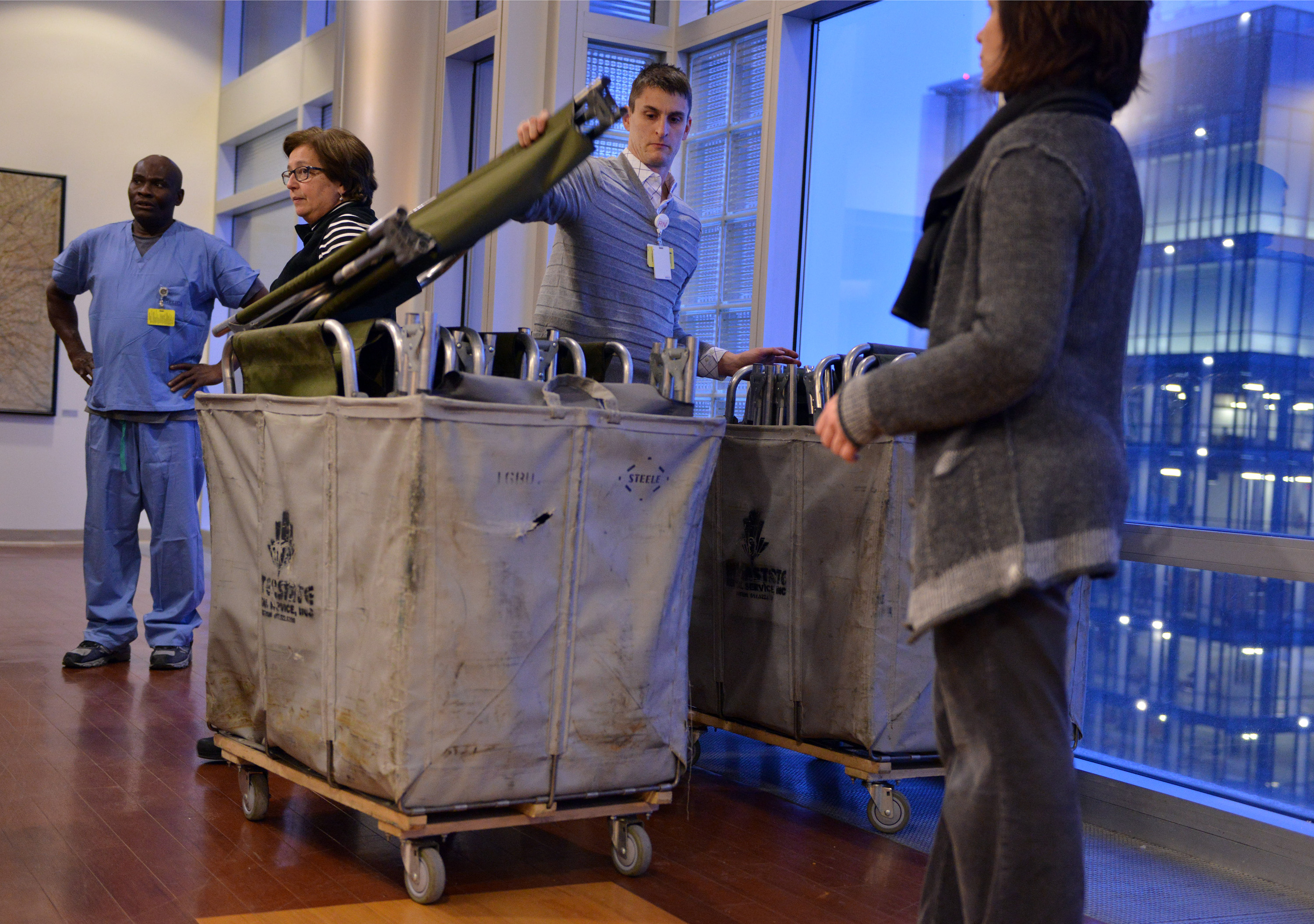 Employees, including Clinical Director of Operations Daniel Nadworny (center), set up cots for workers at Beth Israel Deaconess Medical Center.