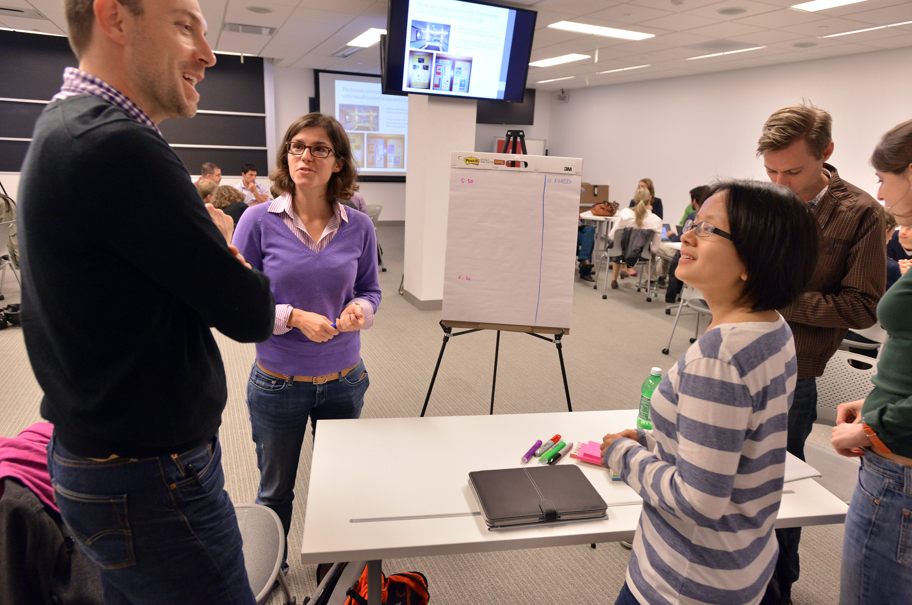 Students discussed a proposal with a professor.