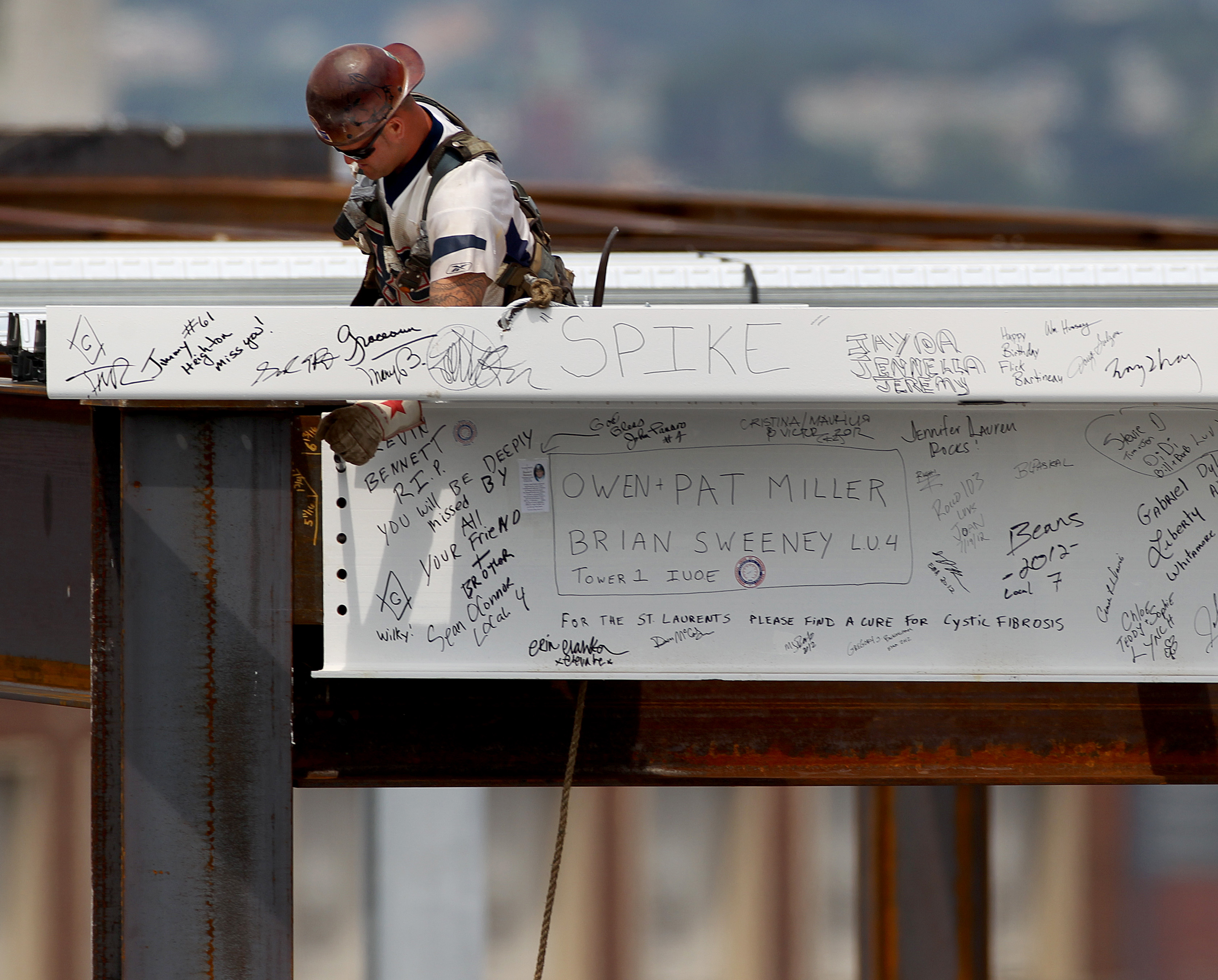 A worker connected a beam at the topping off ceremony at 11 Fan Pier Blvd. in July.