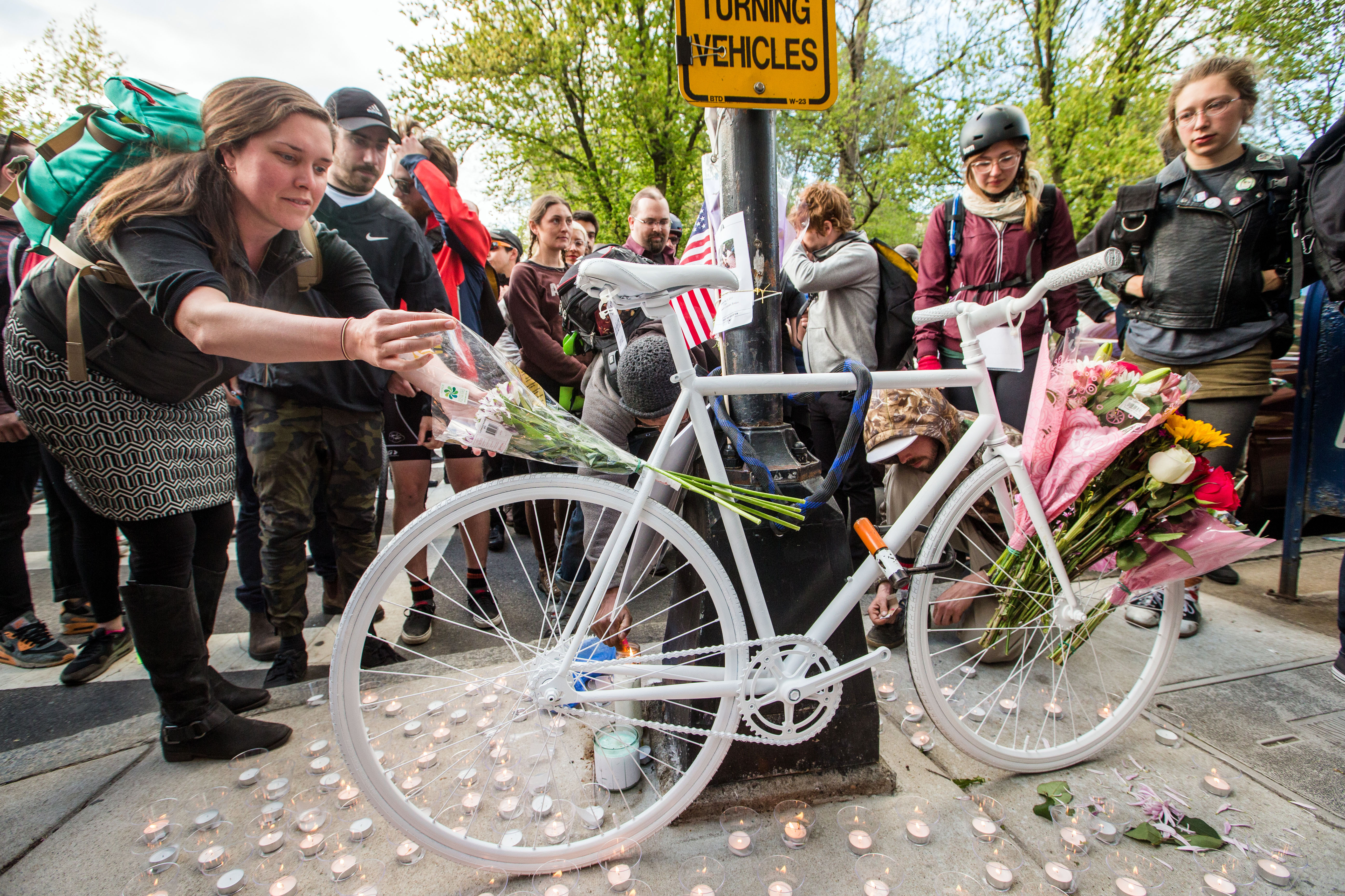 Attendees lit candles around a Ghost Bike placed at the intersection of Clarendon and Commonwealth in Boston in memory of Rick Archer.