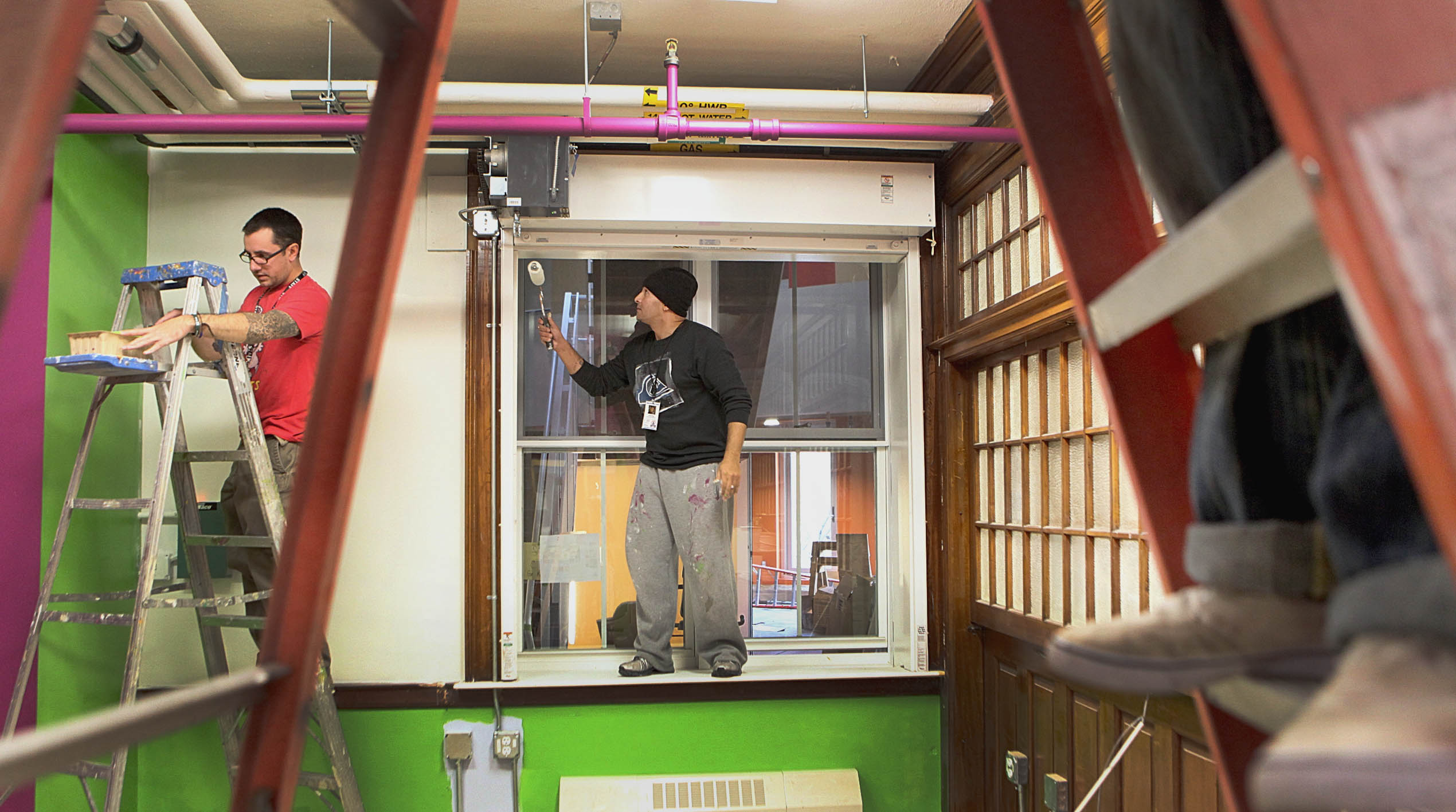 Street workers Jonathan Lunde and Louie Diaz paint an office in the <a href="http://www.utec-lowell.org/" target="_blank">United Teen Equality Center’s new home.</a>