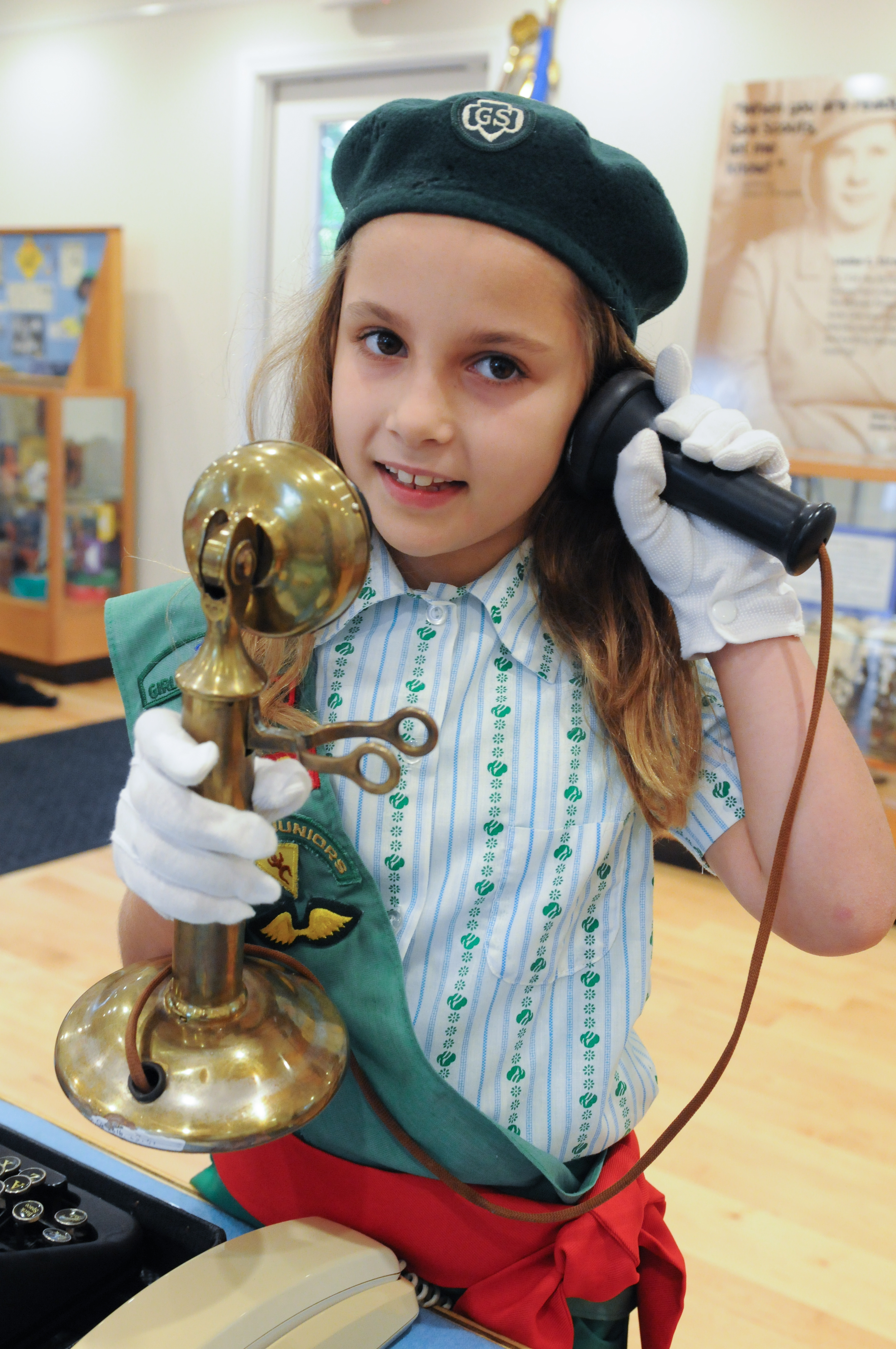 A Girl Scout in vintage uniform learns how people called each other before cell phones.