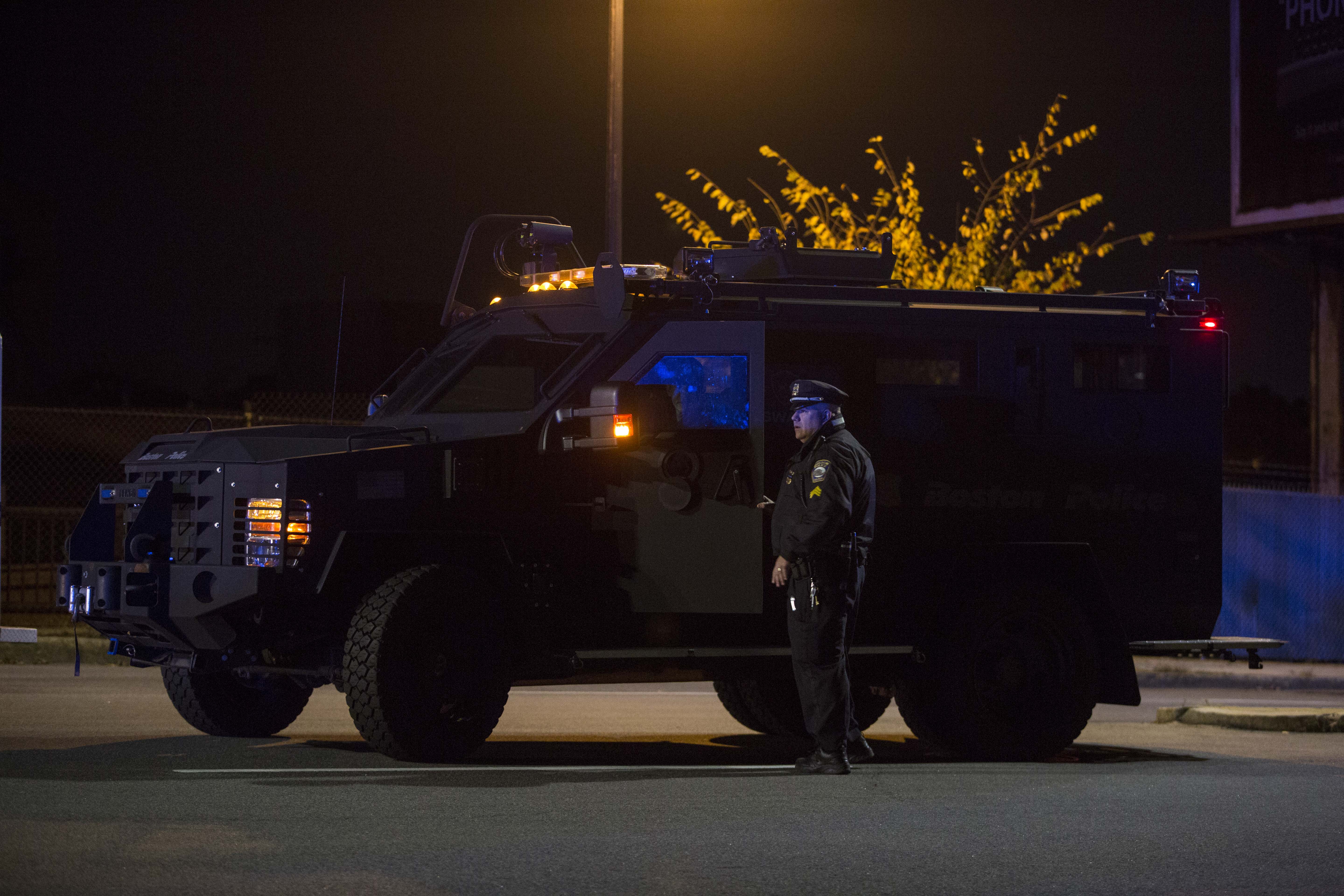 Two officers spoke to each other near a SWAT vehicle at the scene.