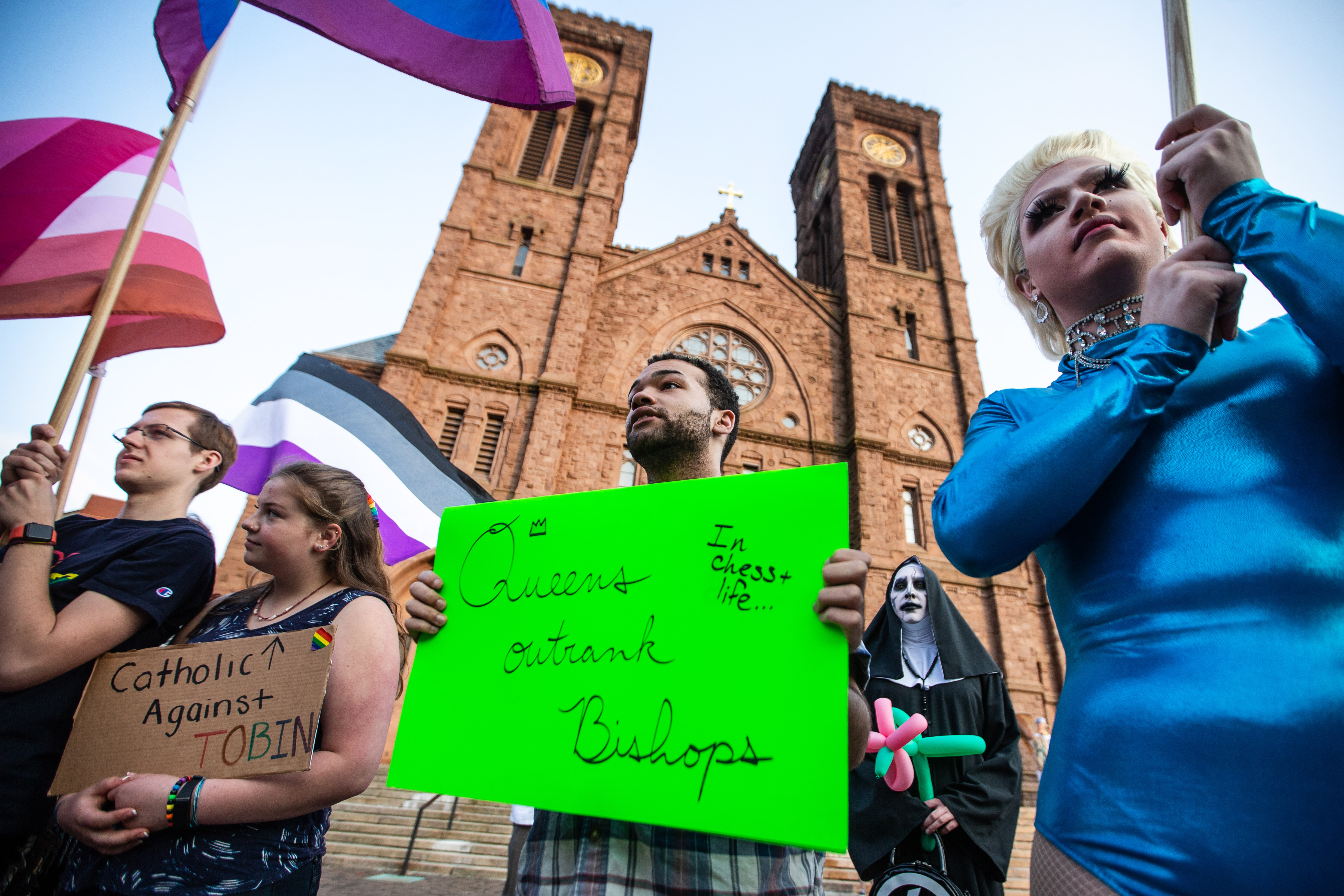 Keenan Mebane, 22, of Providence held a sign at Sunday’s rally.