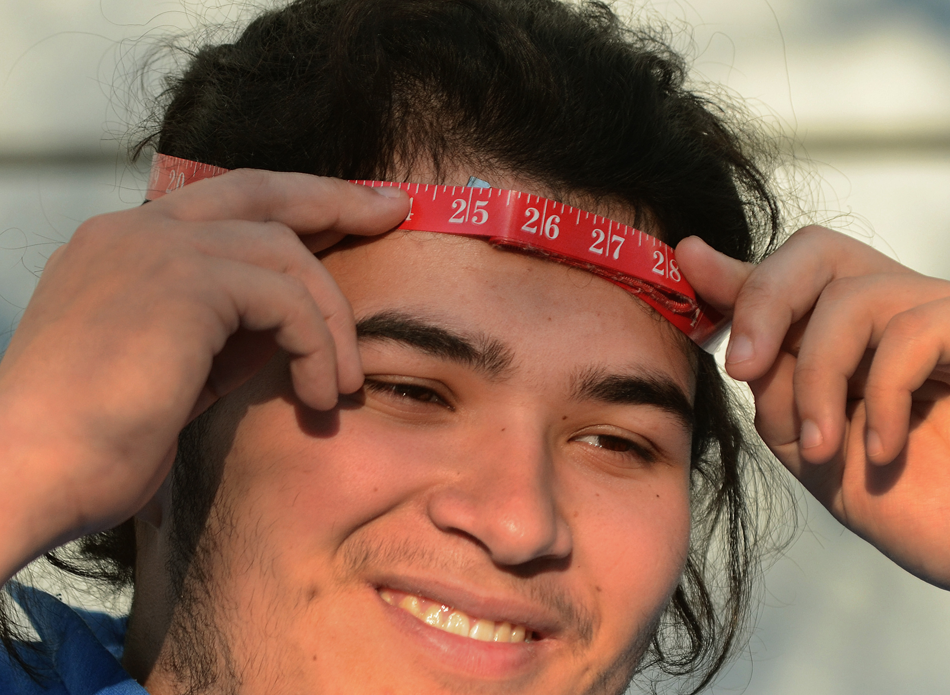 Alex Chu measured his head.