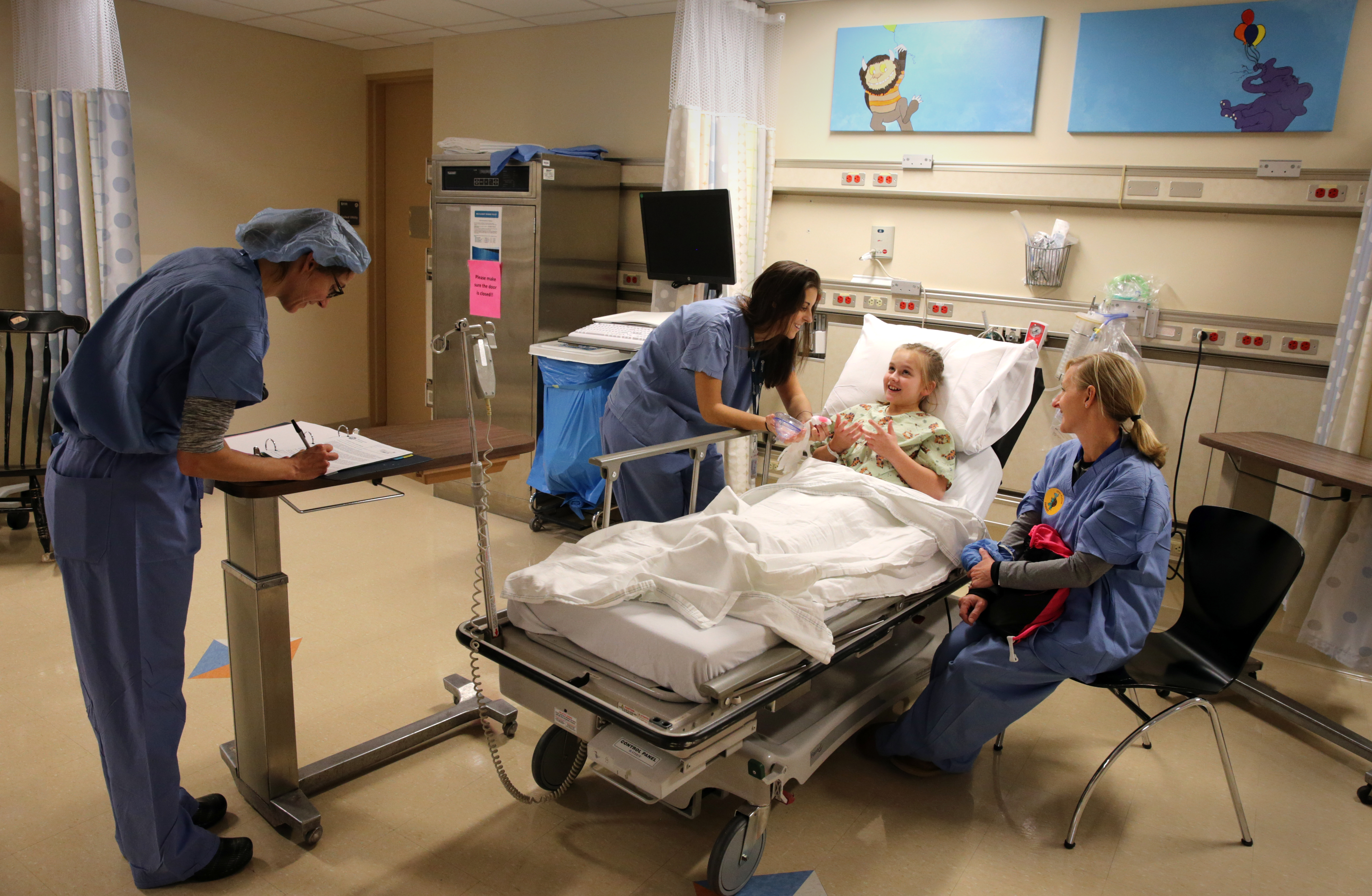 Anesthesiologist Dr. Makara Cayer and child life specialist Brianna Peck talked with Mia Quinn, 11, and her mother Sheila Quinn.