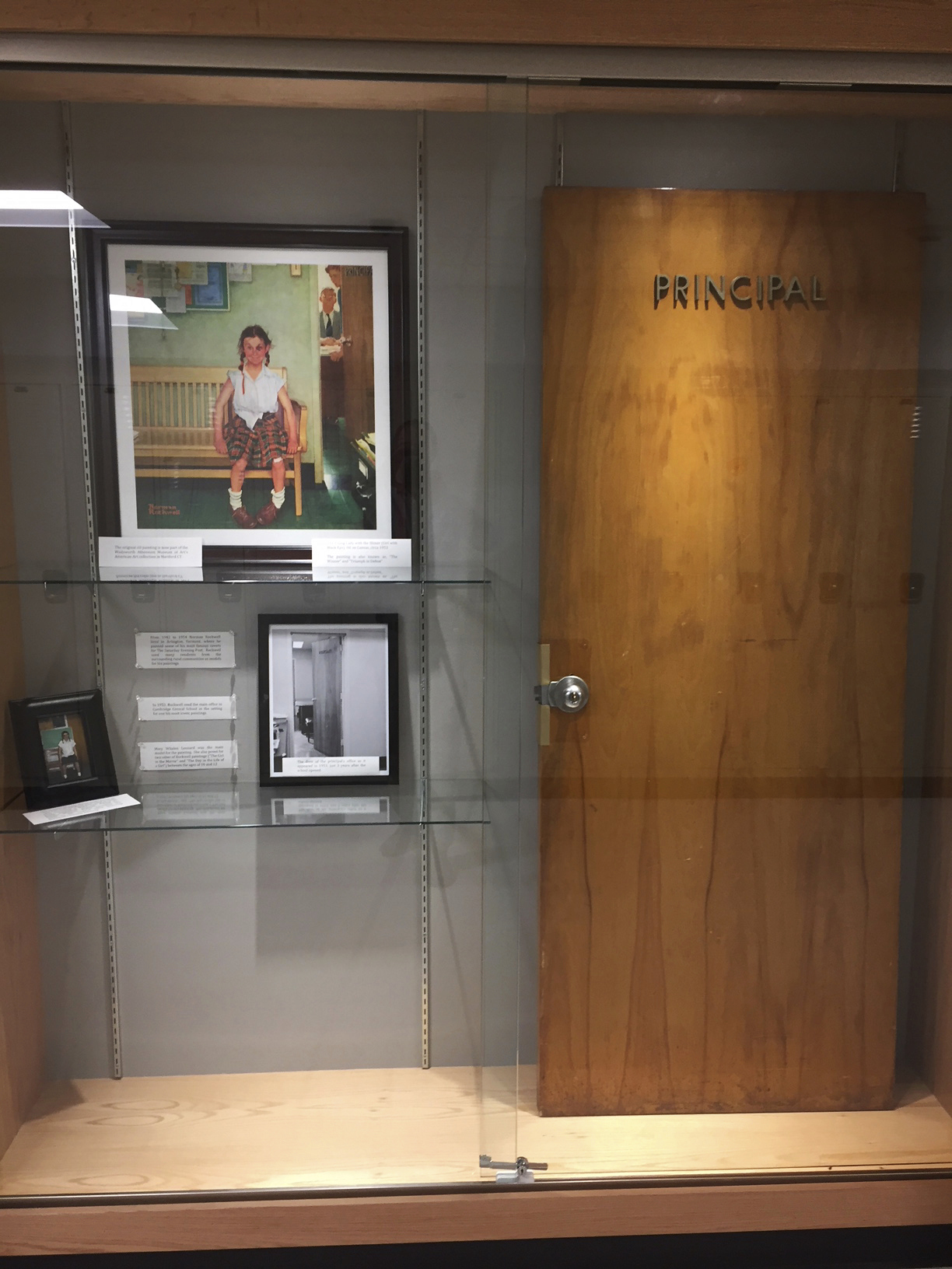 The principal’s door depicted in Norman Rockwell’s “Girl With Black Eye” is now displayed behind glass in Cambridge, N.Y.