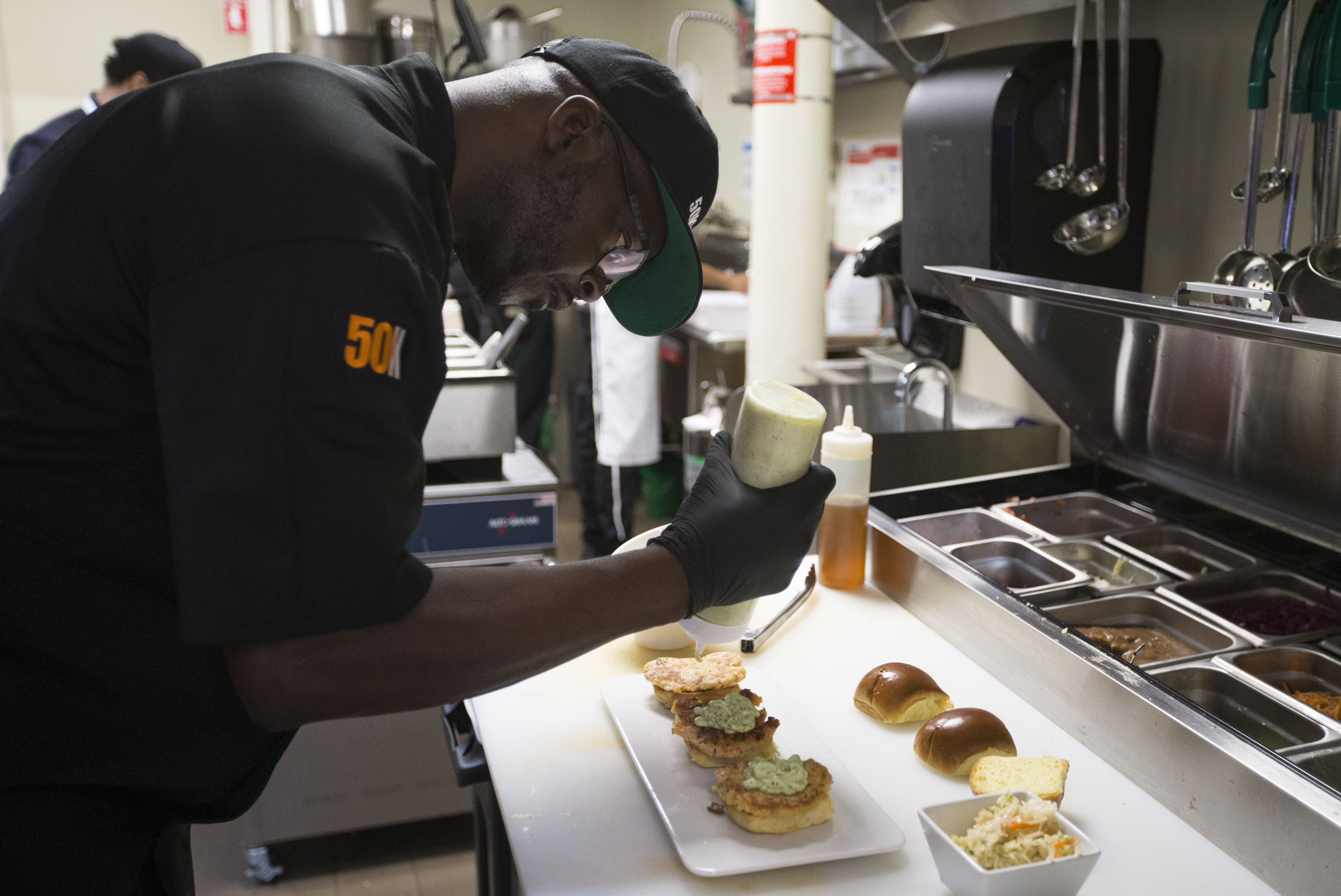 Anthony Caldwell, owner and executive chef at 50Kitchen, finished up some sliders on Friday.