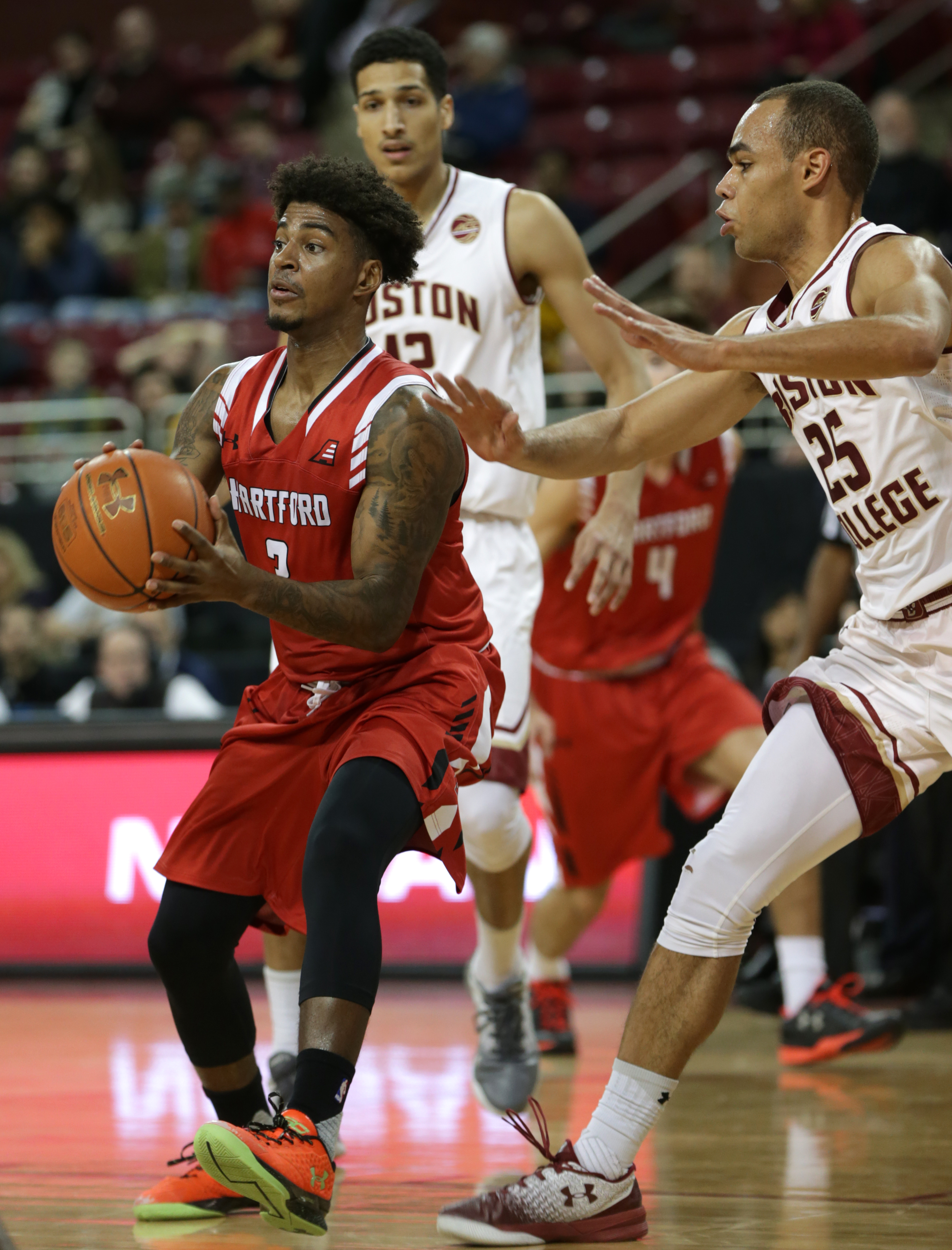 Hartford’s Jalen Ross (left) had BC’s Jordan Chatman (25) on his back in the first half.