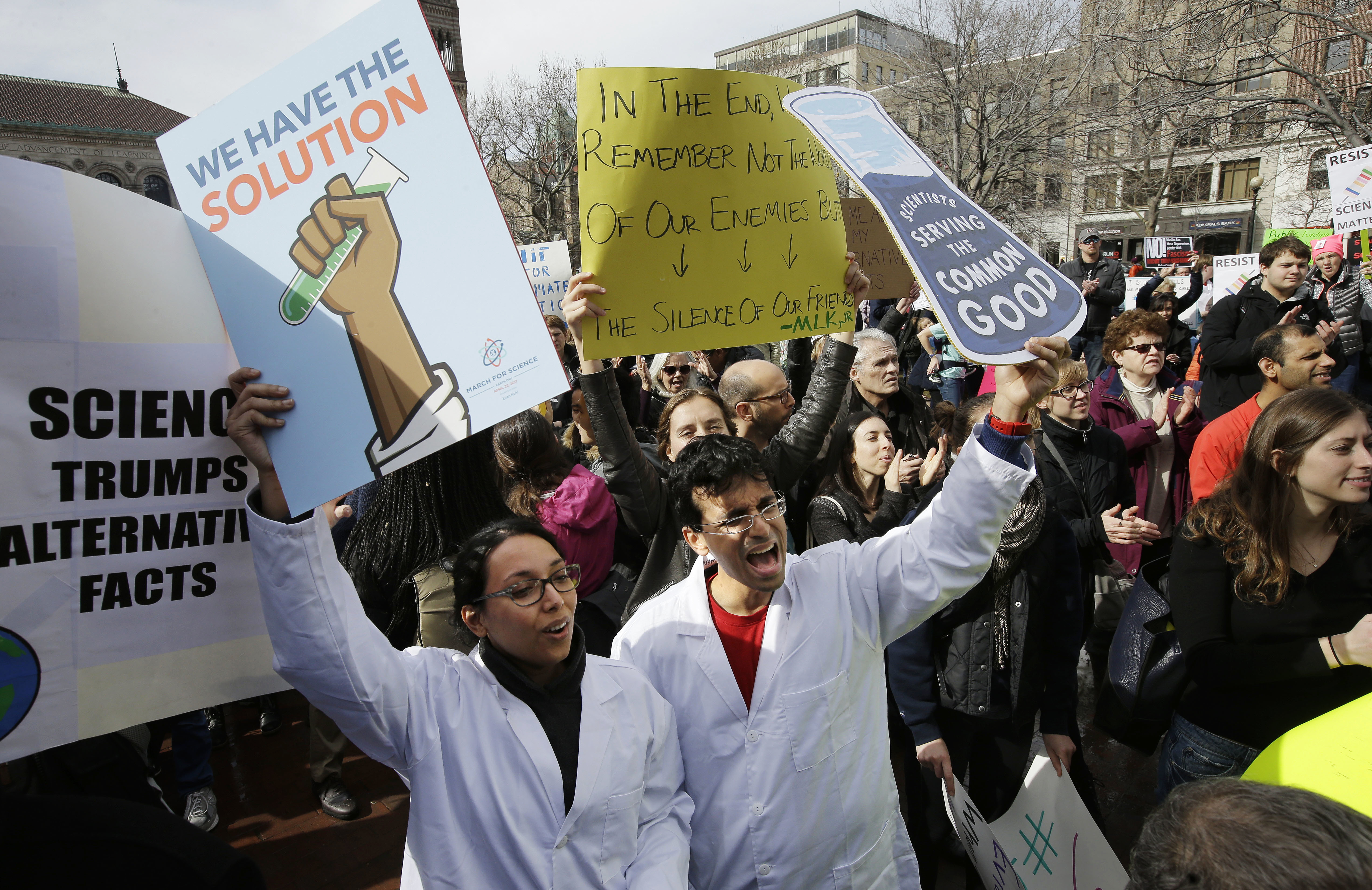 Neuroscientist Shruti Muralidhar, front left, and microbiologist Abhishek Chari, front right, held placards in Copley Square.
