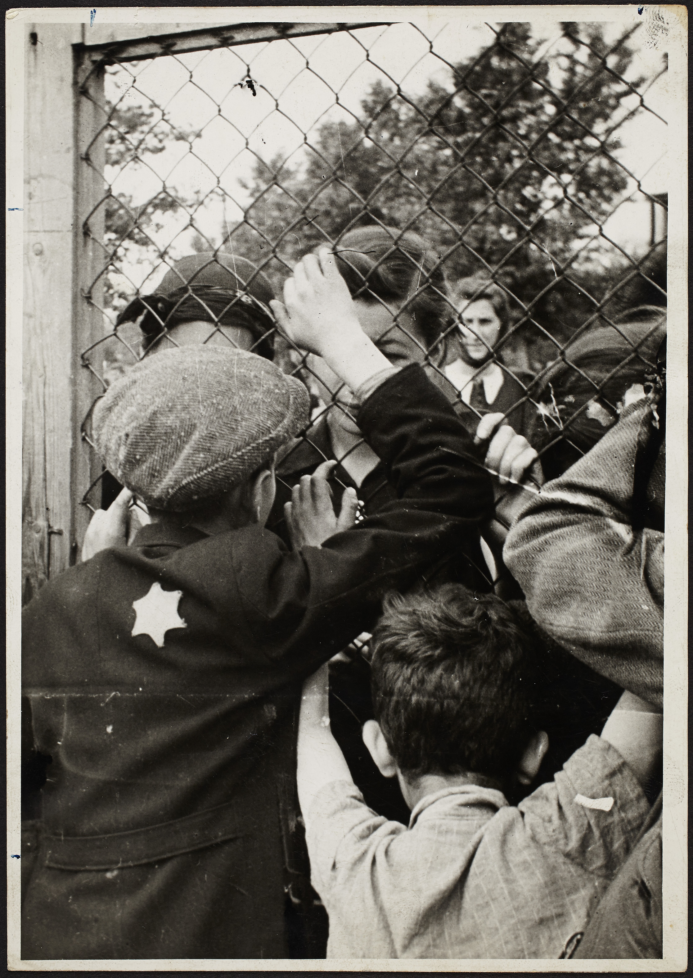 Ross’s photo of children talking through the fence of a prison in the Lodz Ghetto prior to deportation, from the MFA exhibit.