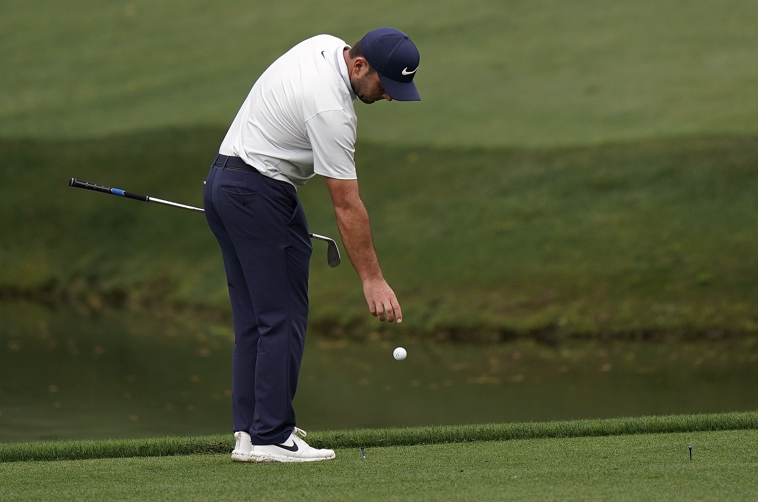 Francesco Molinari takes a drop on the fateful 12th hole, the first of his two double bogeys.