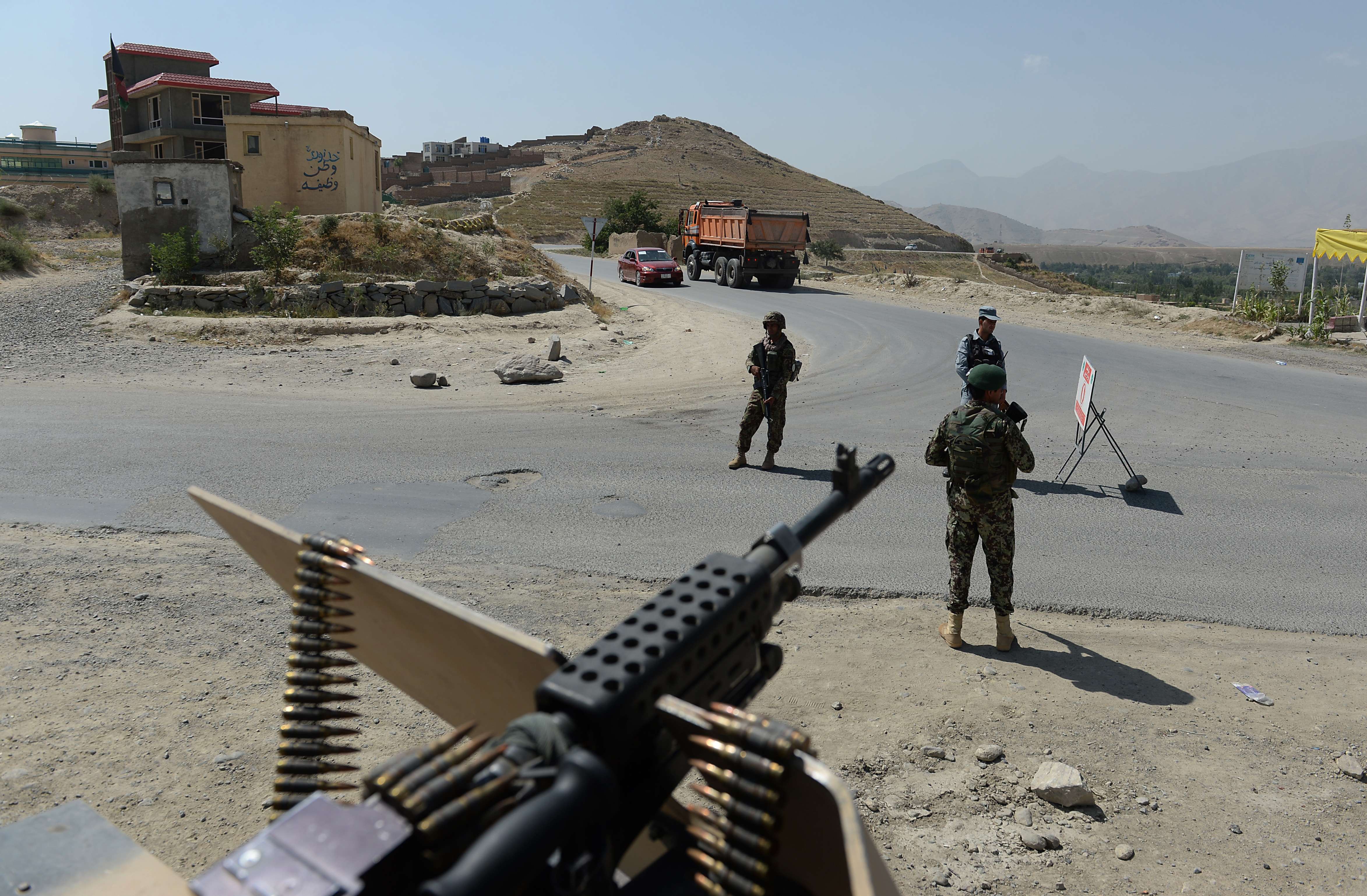 Afghan National Army soldiers keep watch at a checkpoint on the outskirts of Kabul on Aug. 6.