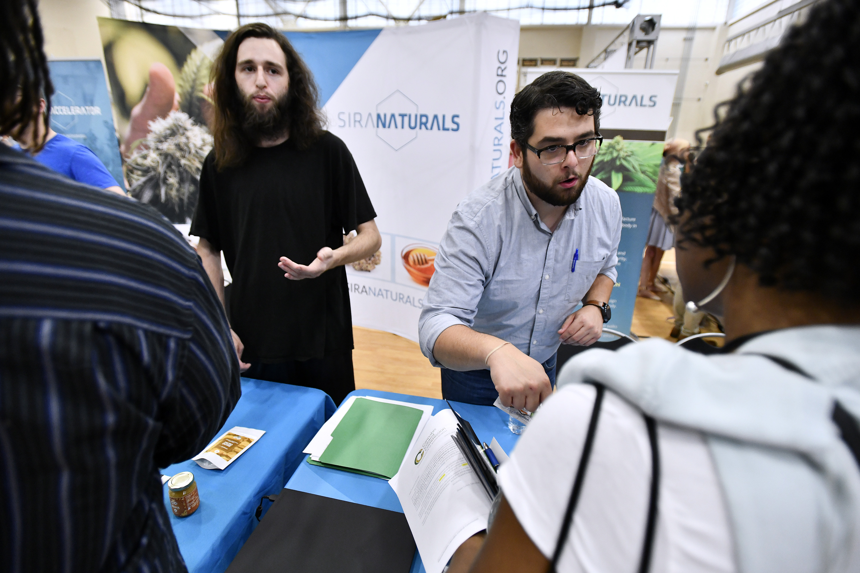 Processing technician Aaron Wang and director of marketing Nic DiBella of Sira Naturals spoke with prospective employees at the job fair.