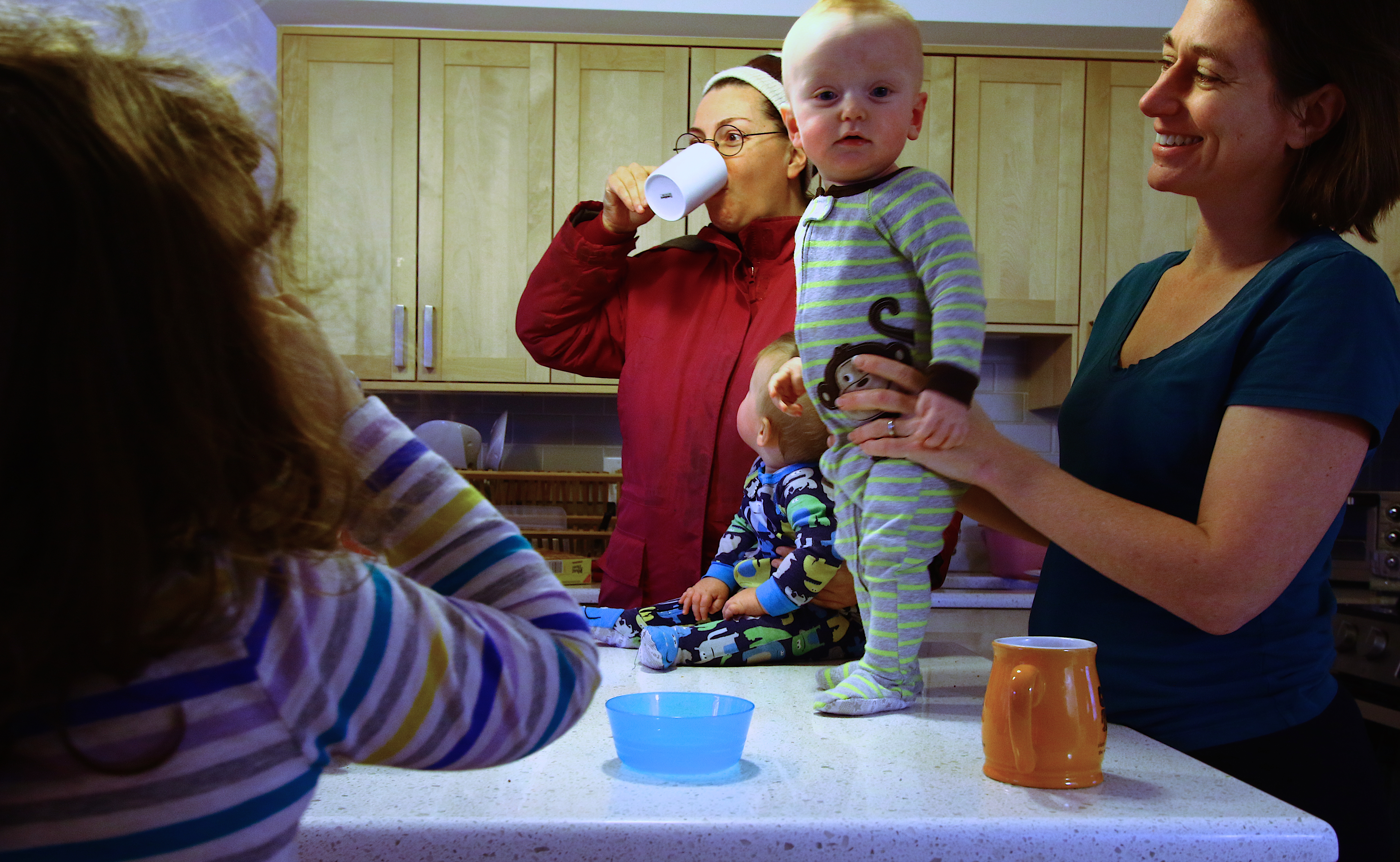 Melissa Paschall and her twin boys, Zachary and Jason, 9 months, along with neighbor and friend Jenise Aminoff, enjoy a cup of coffee after a Saturday afternoon of playing in the common areas at Cornerstone Village.