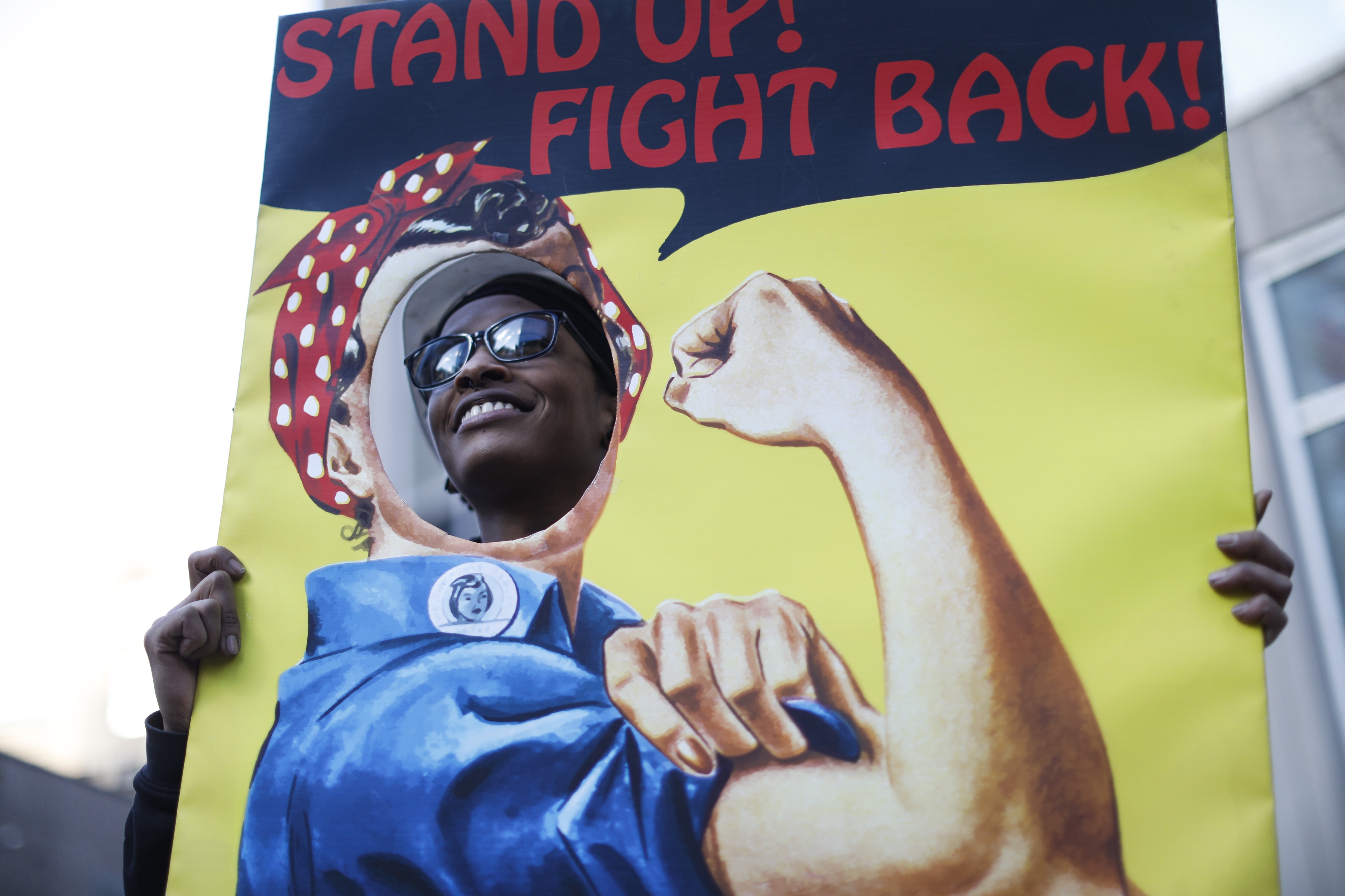 Quiana Ferguson held a “Rosie the Riveter” poster in Downtown Crossing.