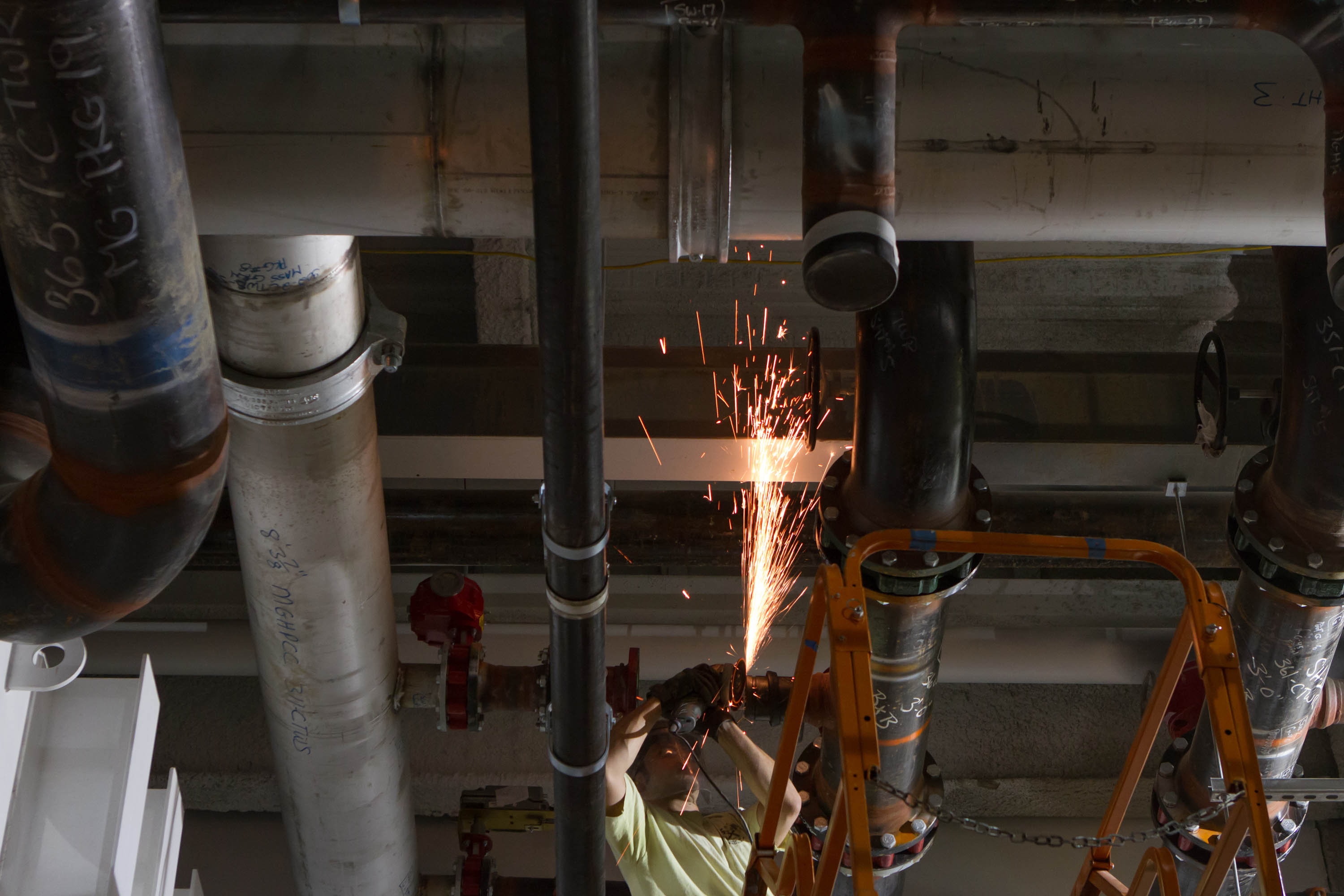 A welder cut a water pipe inside the Massachusetts Green High Performance Computing Center, which will use hydropower and other energy-efficient technologies.