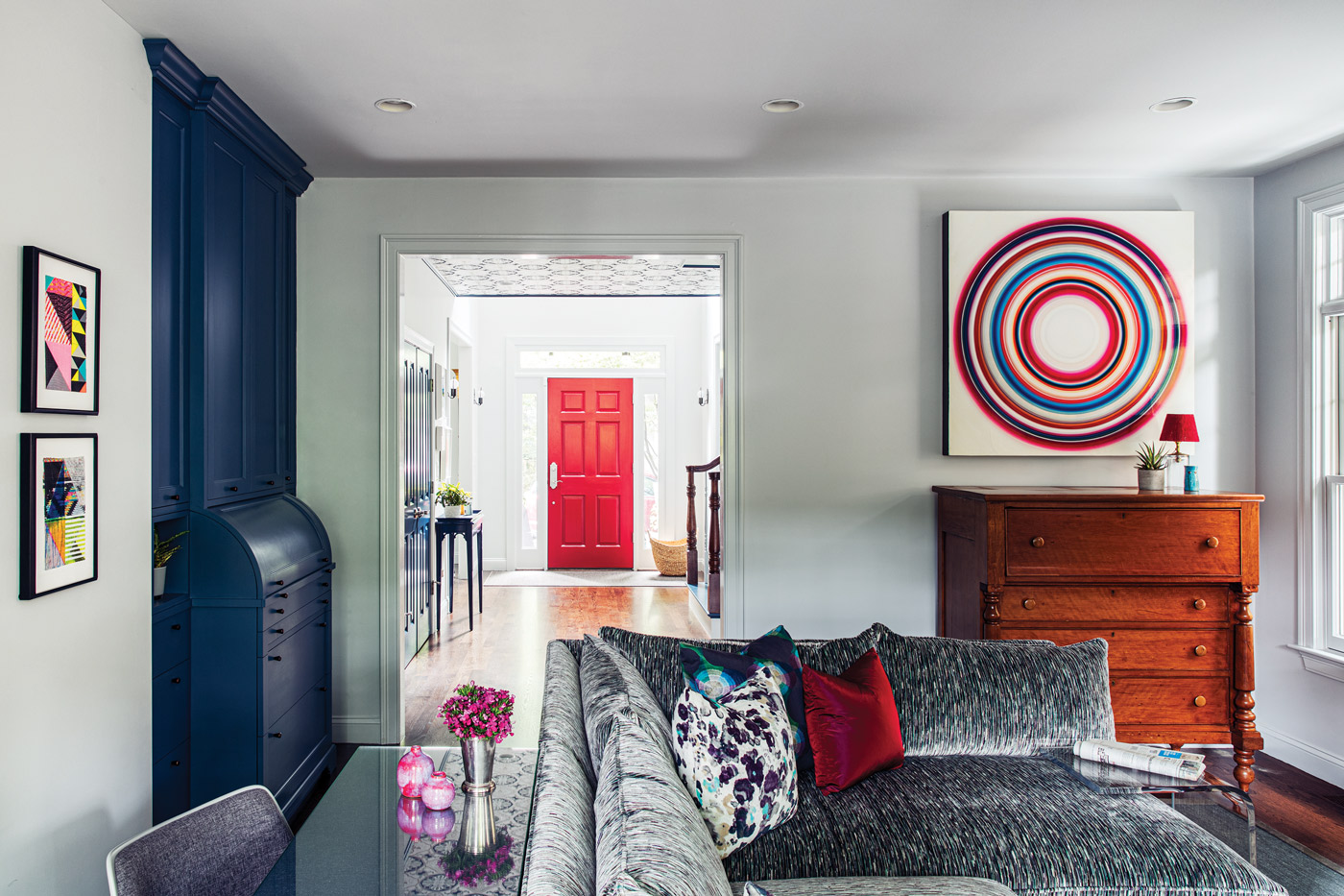 In the family room, Michael Hoffman’s Noche Barcelona hangs over an antique cherry butler. Egan designed the built-in roll-top desk.