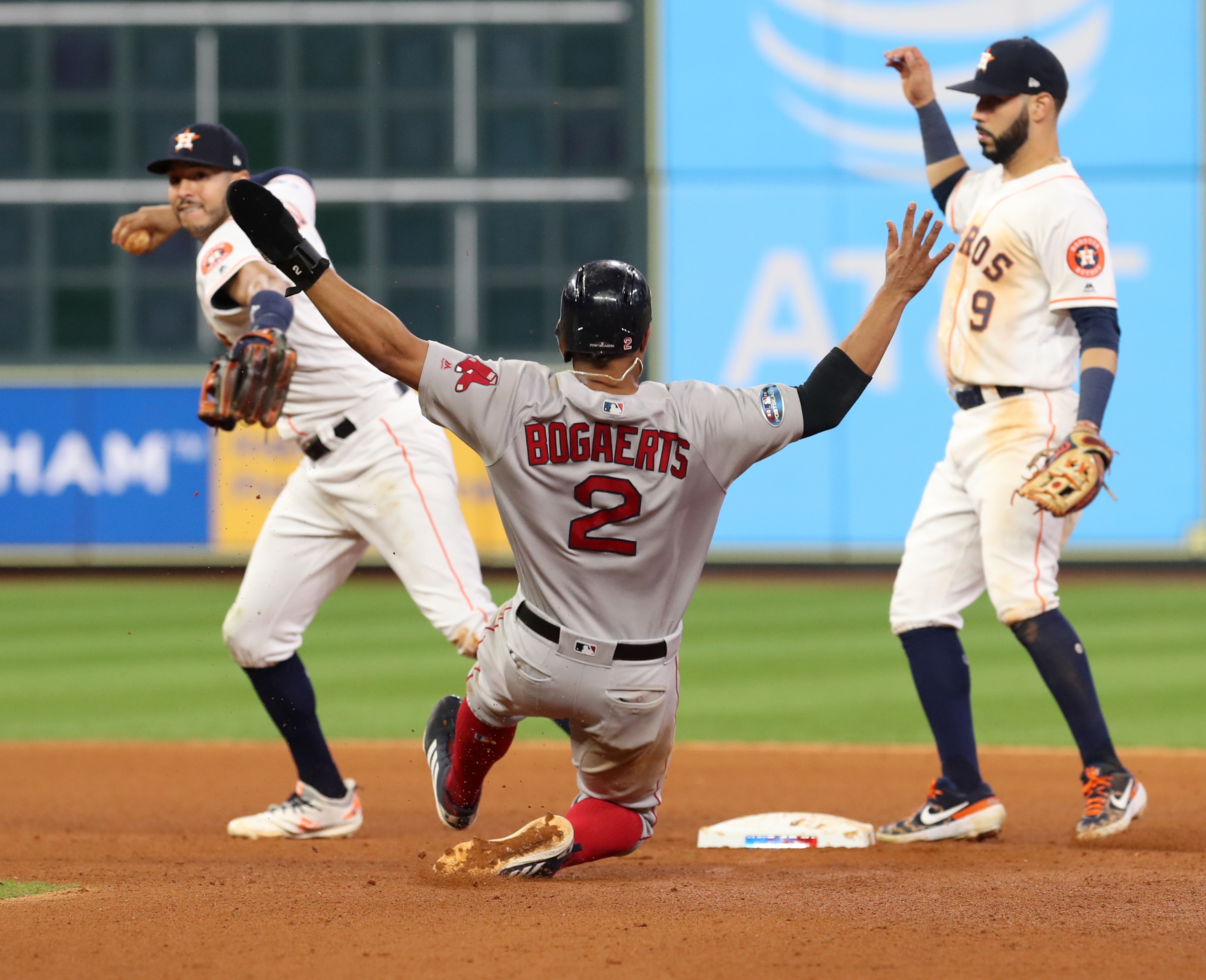 Xander Bogaerts slides safely into second in the seventh inning after Carlos Correa failed tag the base.