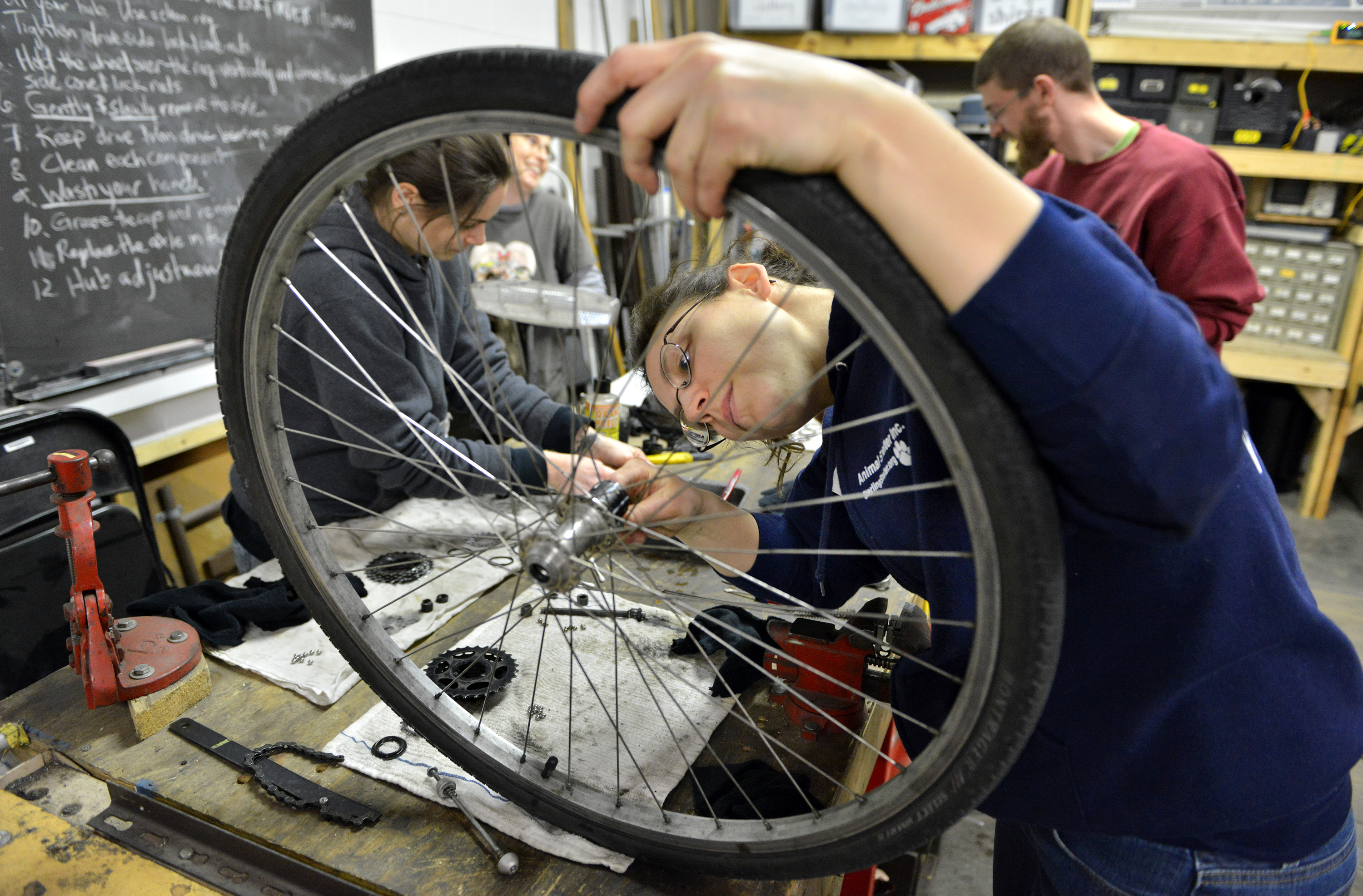 Kathy Kennedy performed an overhaul on a wheel hub in a bicycle maintenance class.