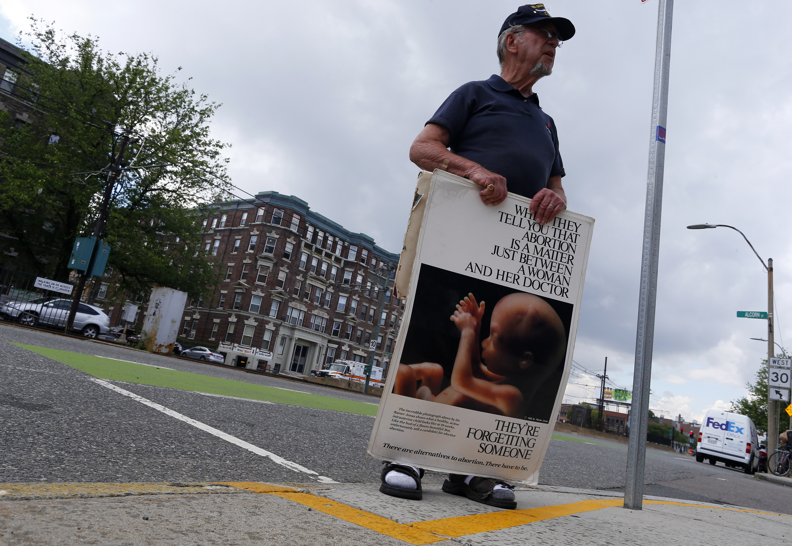 Ray Neary stood behind the yellow line as he protested outside of a Planned Parenthood on Commonwealth Avenue in Boston.