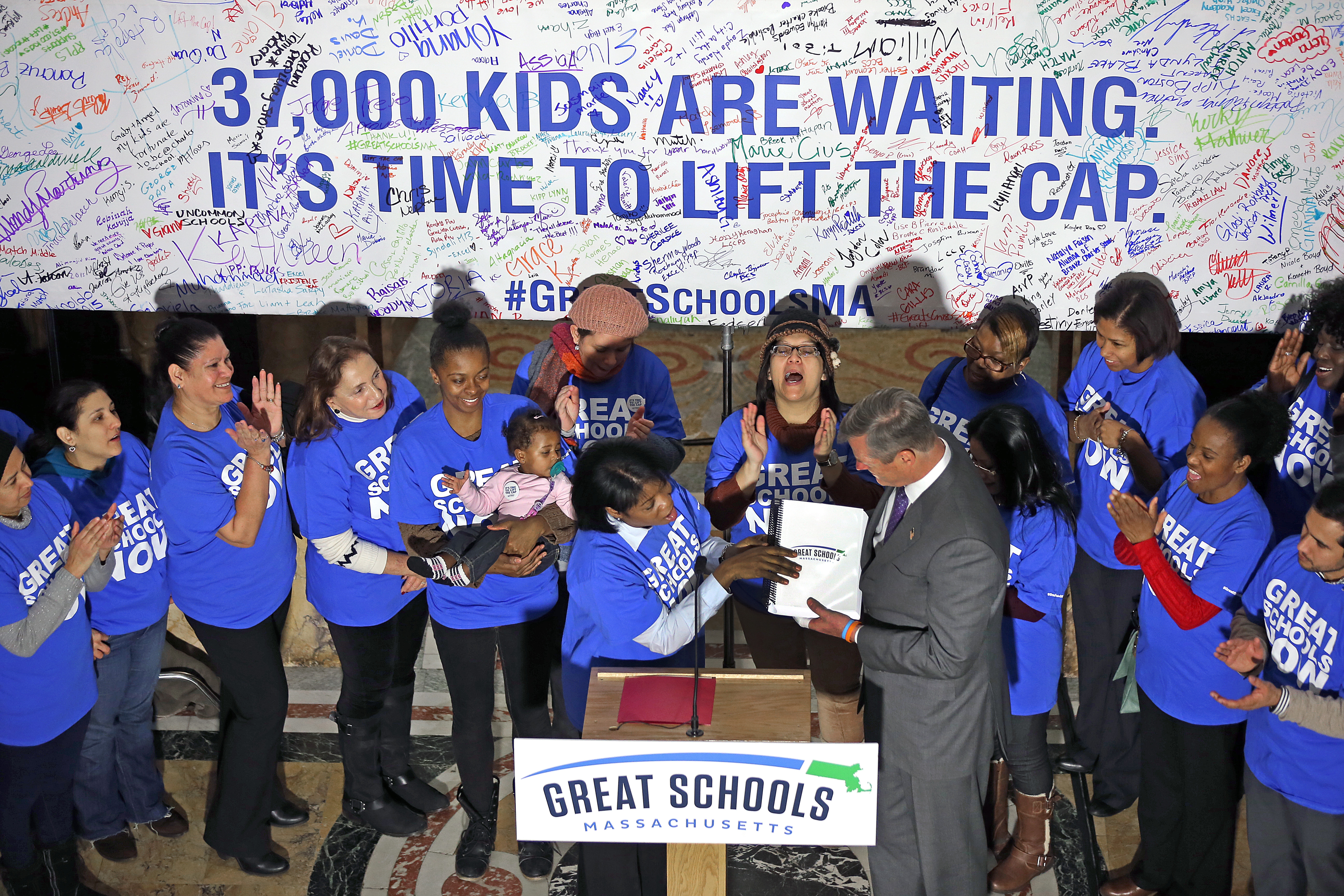 Dawn Foye handed Governor Charlie Baker a charter school petition at the State House in January. Foye’s child attends a charter school.