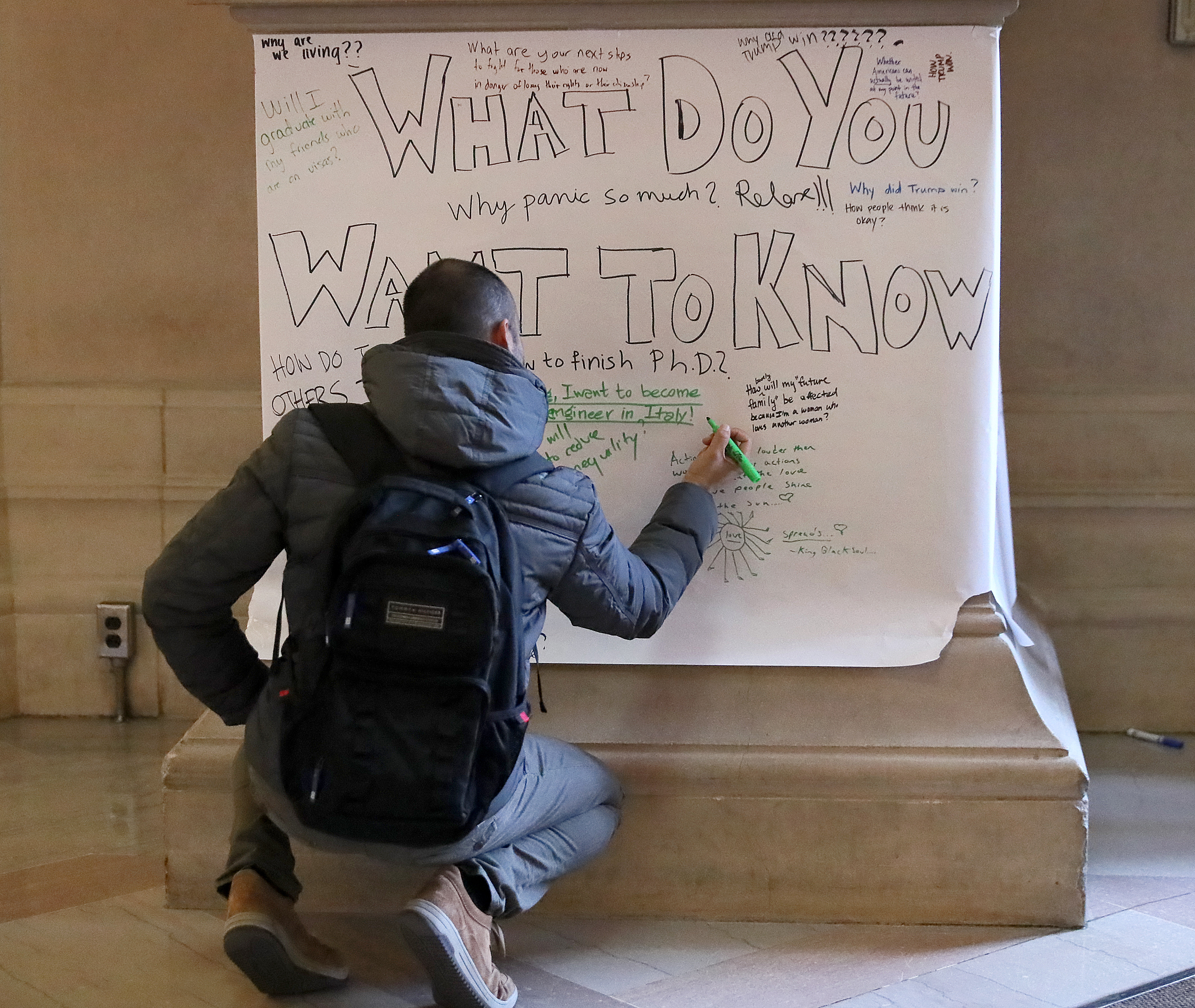 Robert Onidi wrote a note on one of the posters placed on columns in MIT’s Lobby 7.