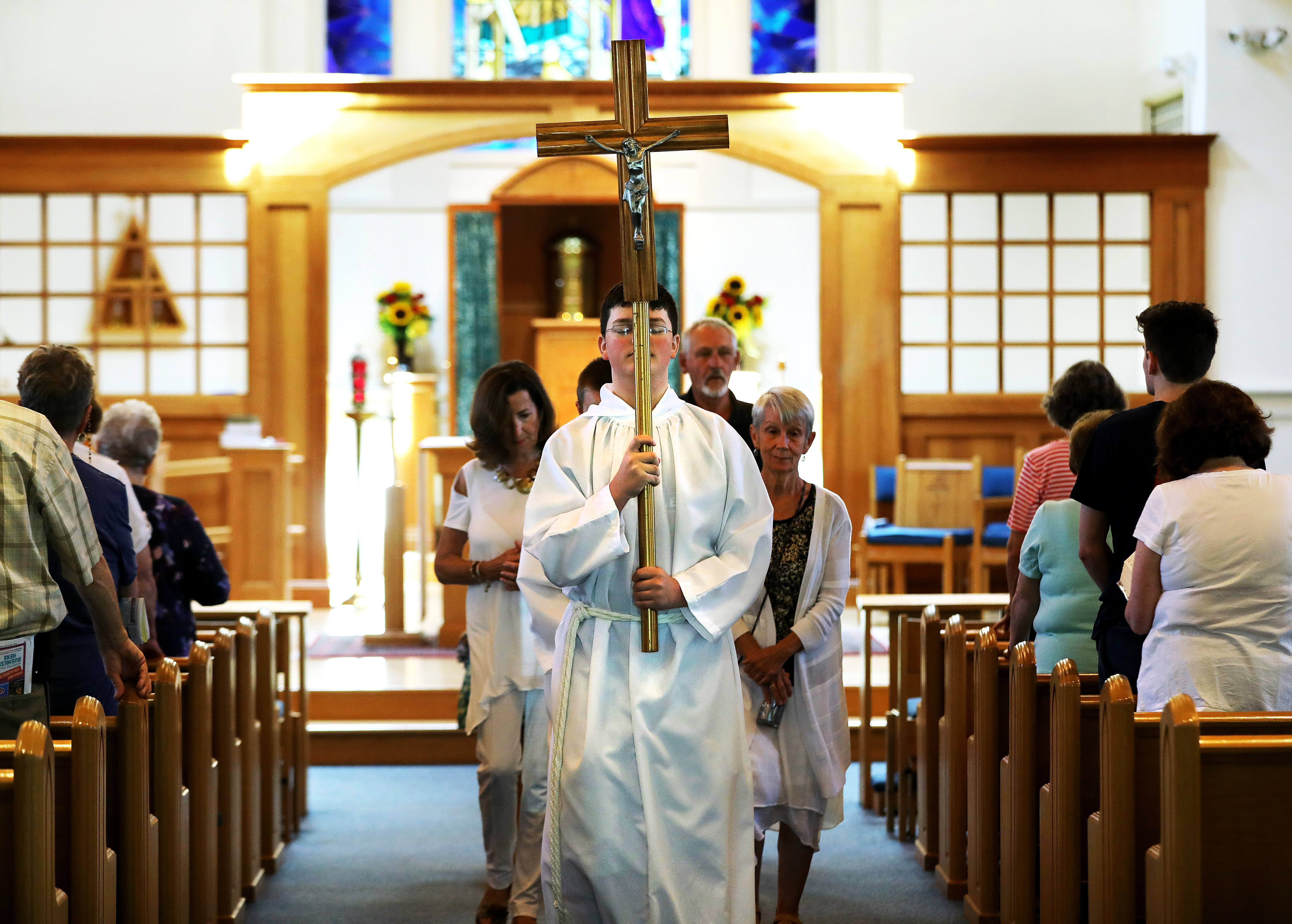 Altar server Adam Short led the recessional after Mass.