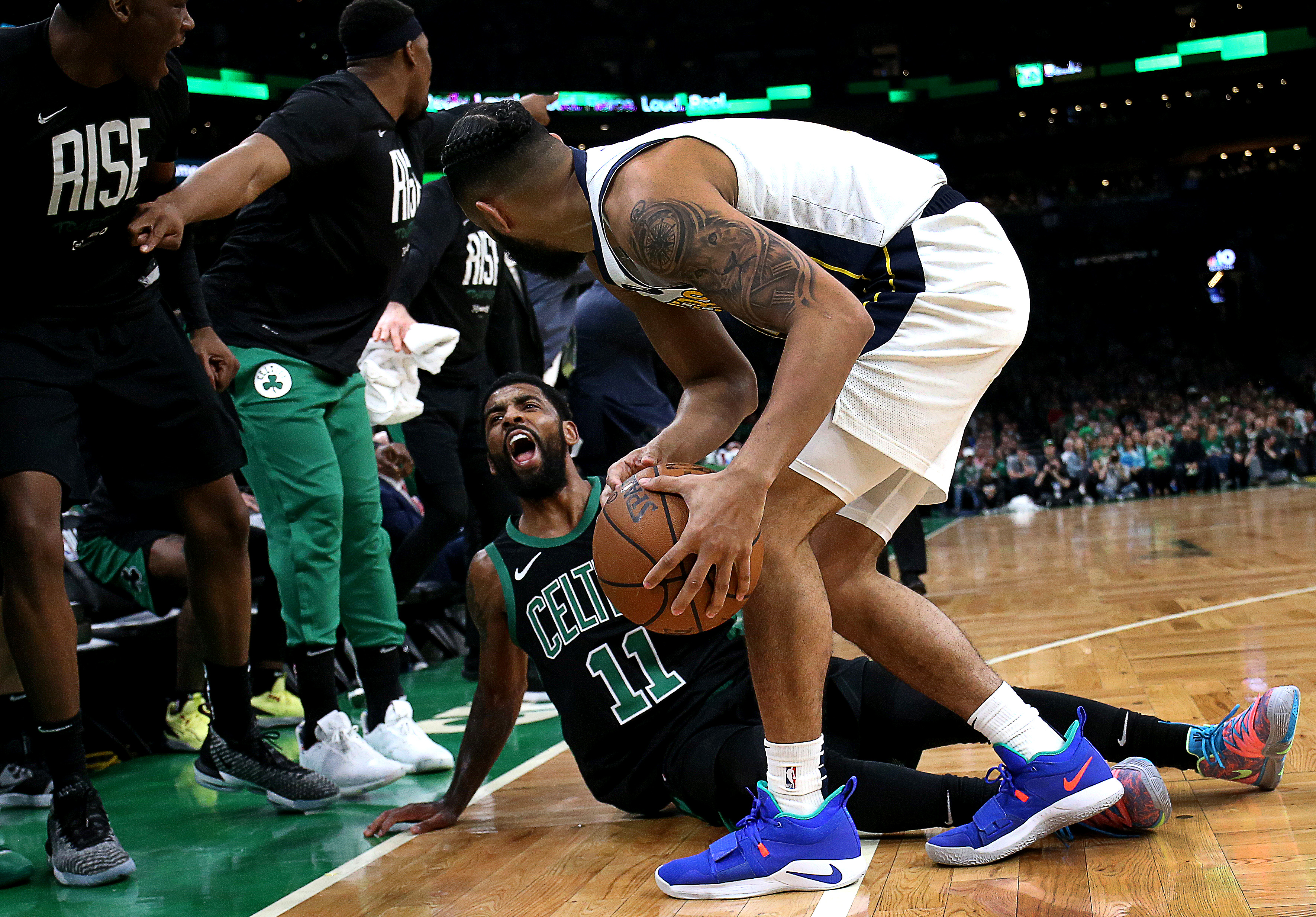 Celtics guard Kyrie Irving battles with Pacers guard Cory Joseph for control of a loose ball in the second half.