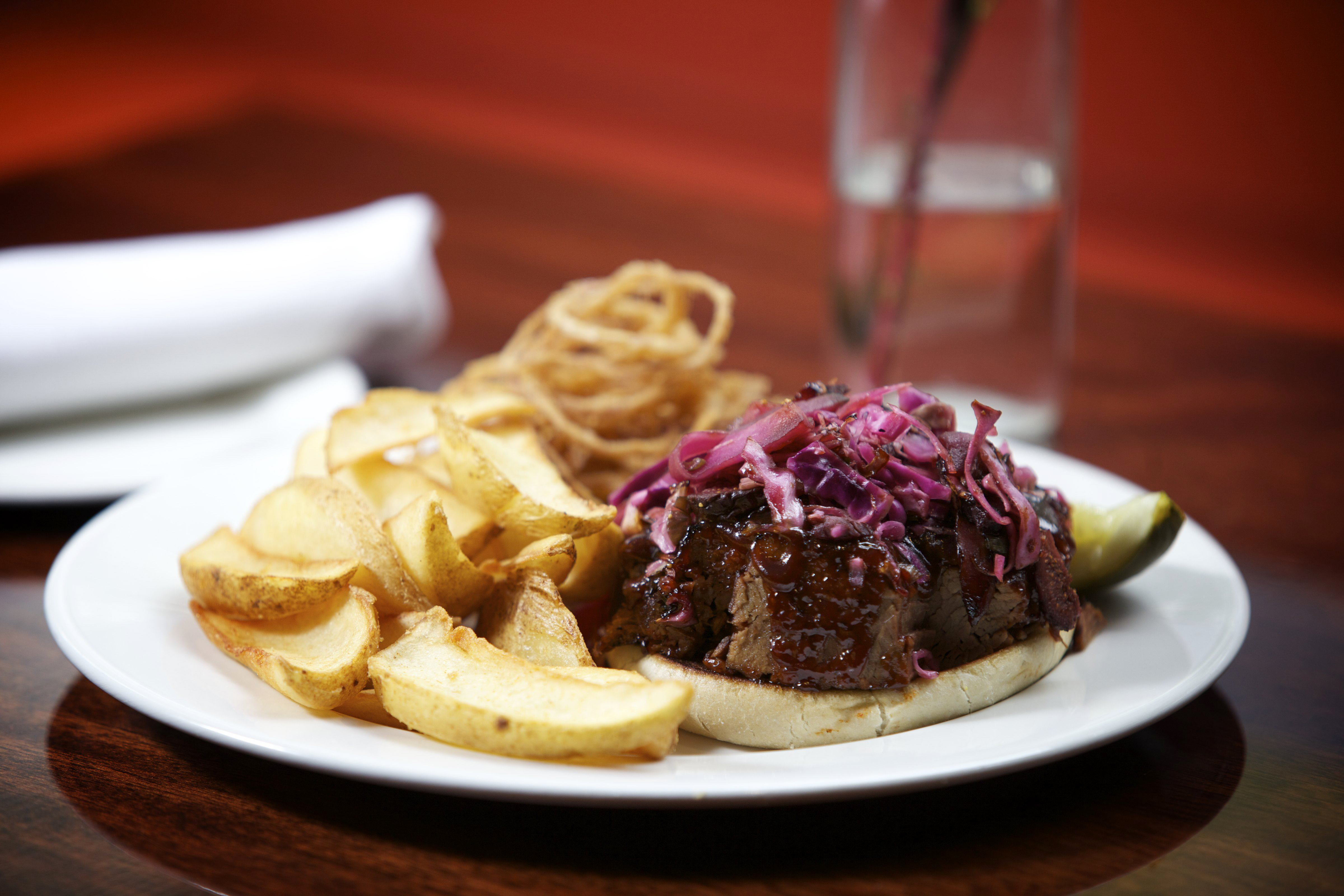The brisket sandwich at First Printer is served on a toasted roll with crunchy battered onions.