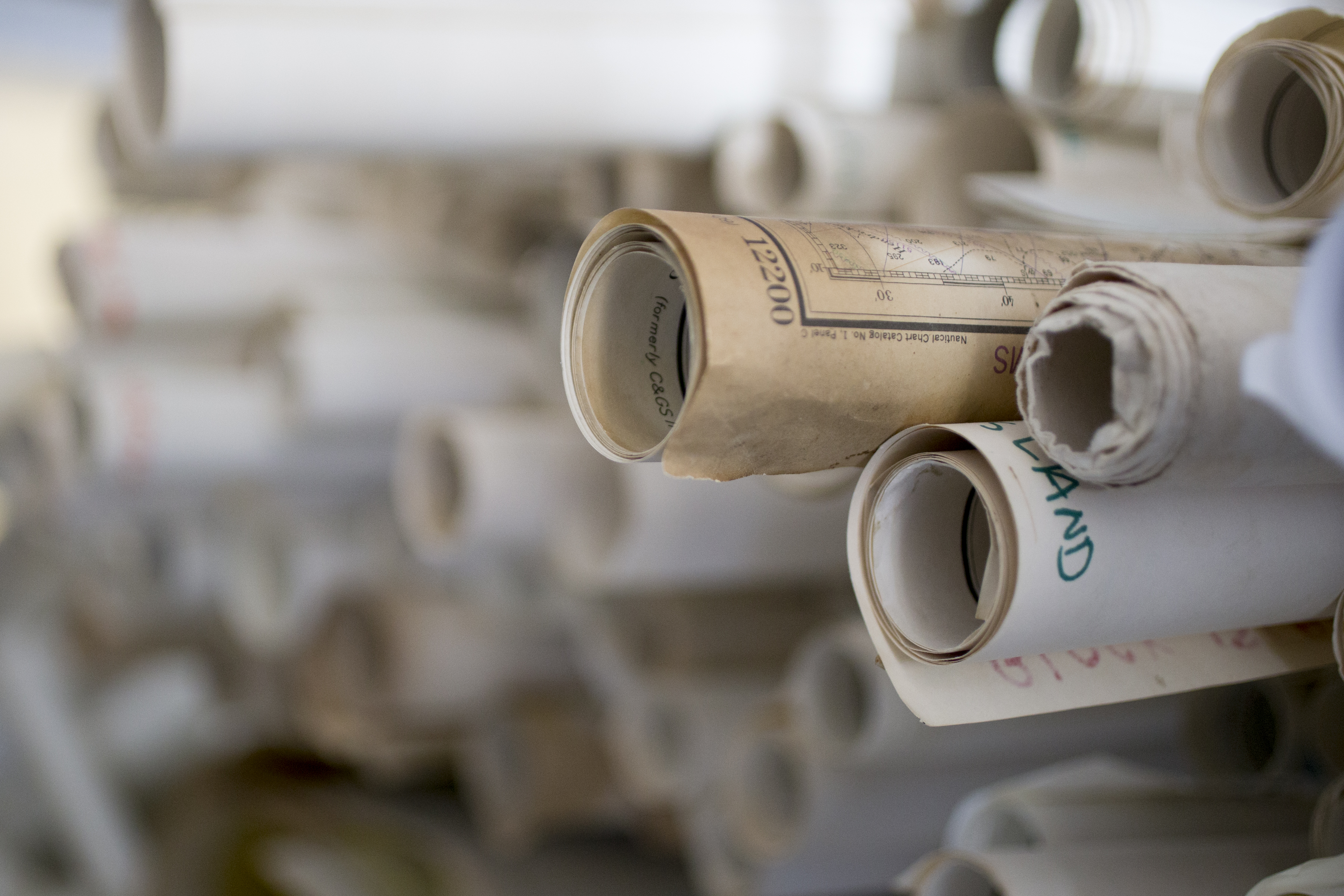 Some of the many nautical charts used to create cufflinks at York River Traders in Holbrook.