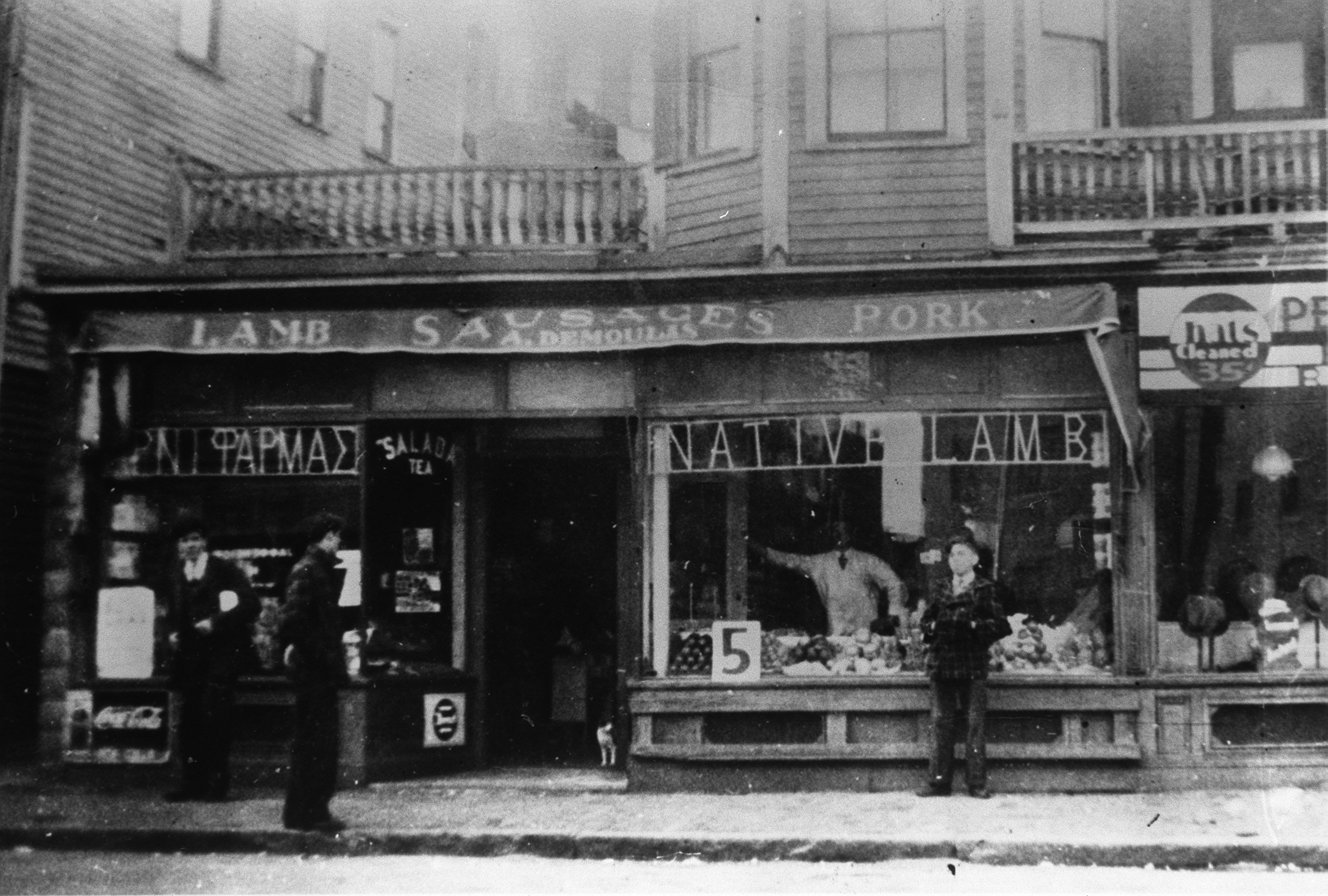 Mike Demoulas, shown in the window of his family’s Lowell store, and brother George worked together to build the chain.