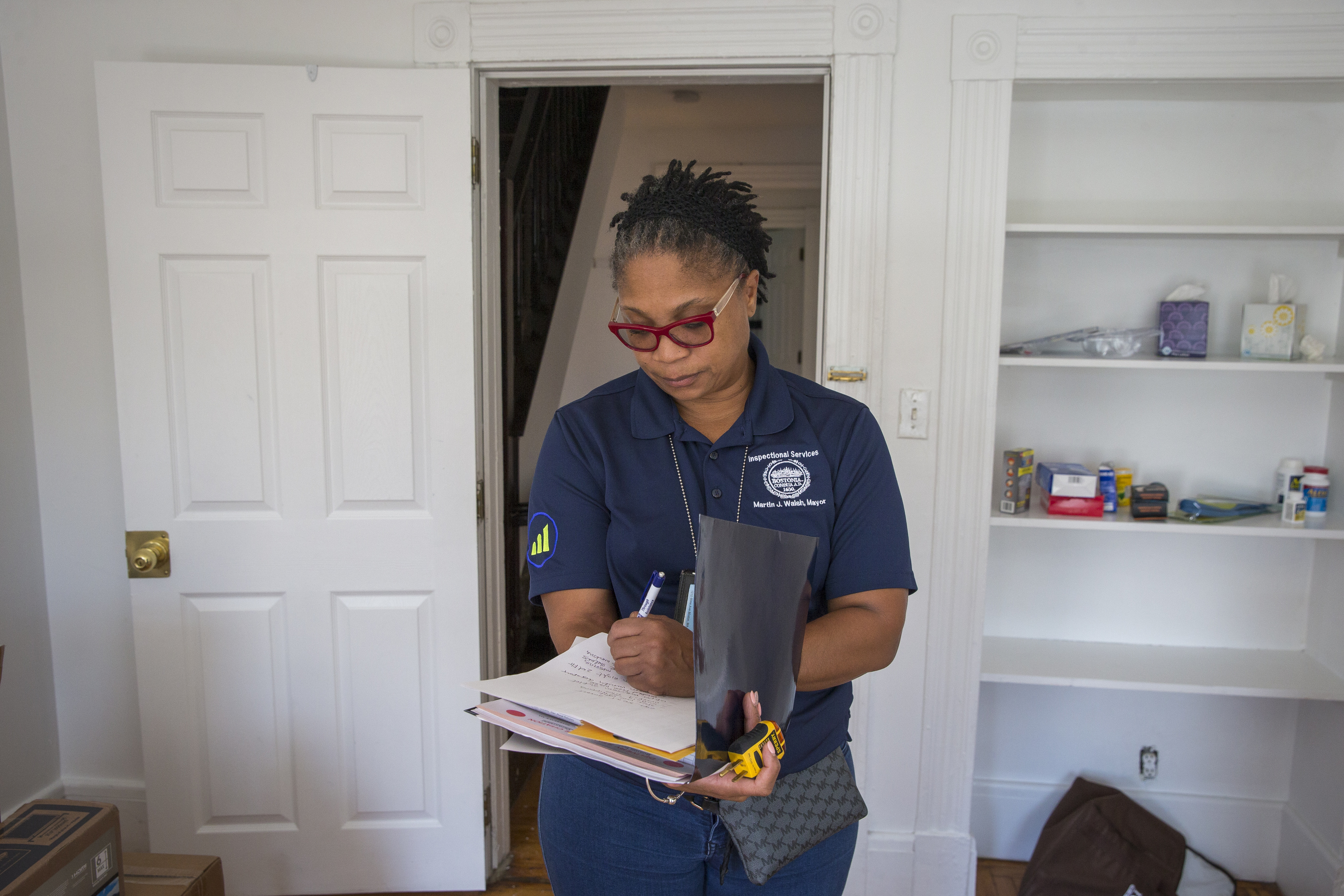 Inspector Sherea McLaughlin checked a home in Allston Sunday. During college move-in, the city steps up code enforcement.
