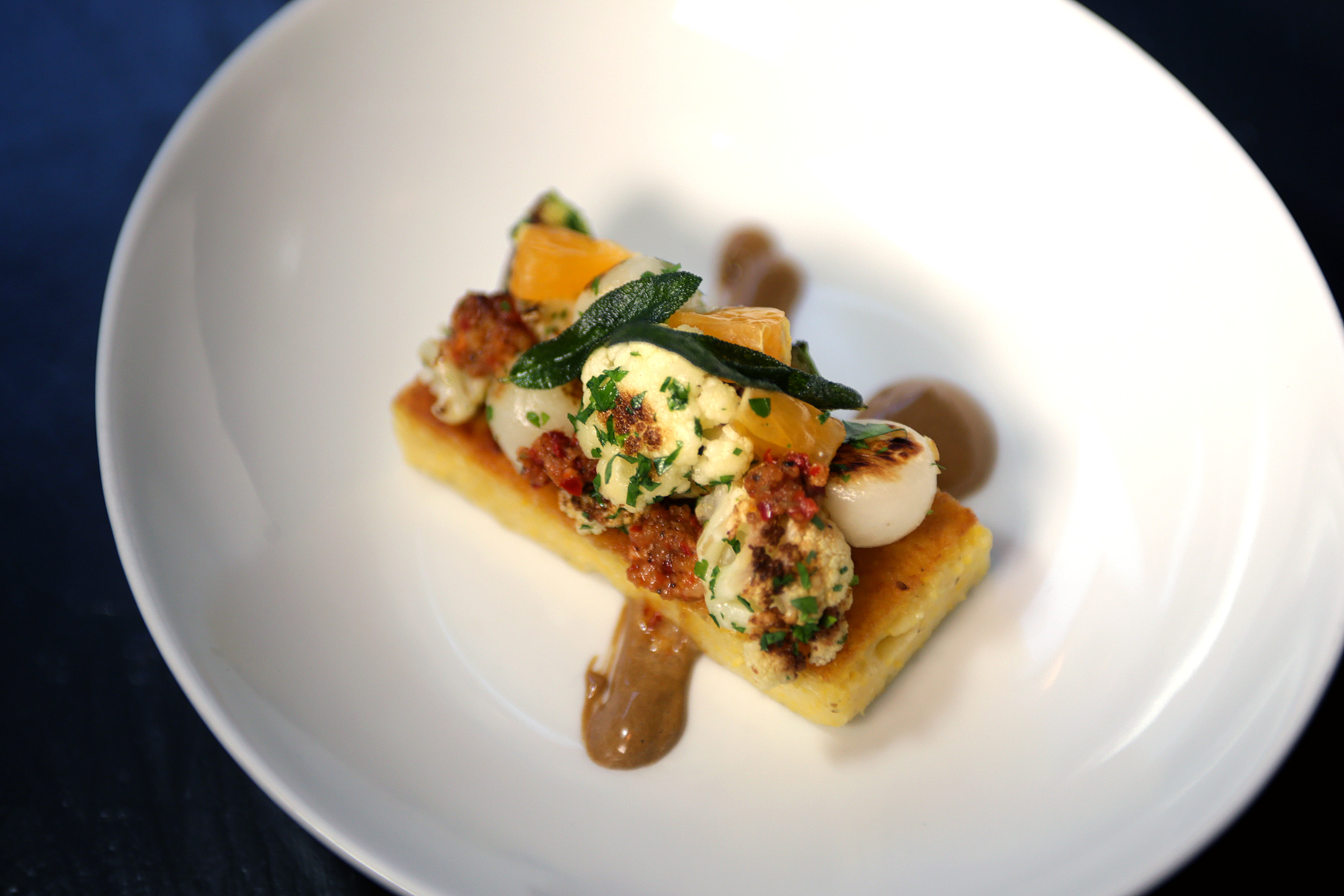 Polenta with turnips and cauliflower florets, nduja, and black garlic aioli.