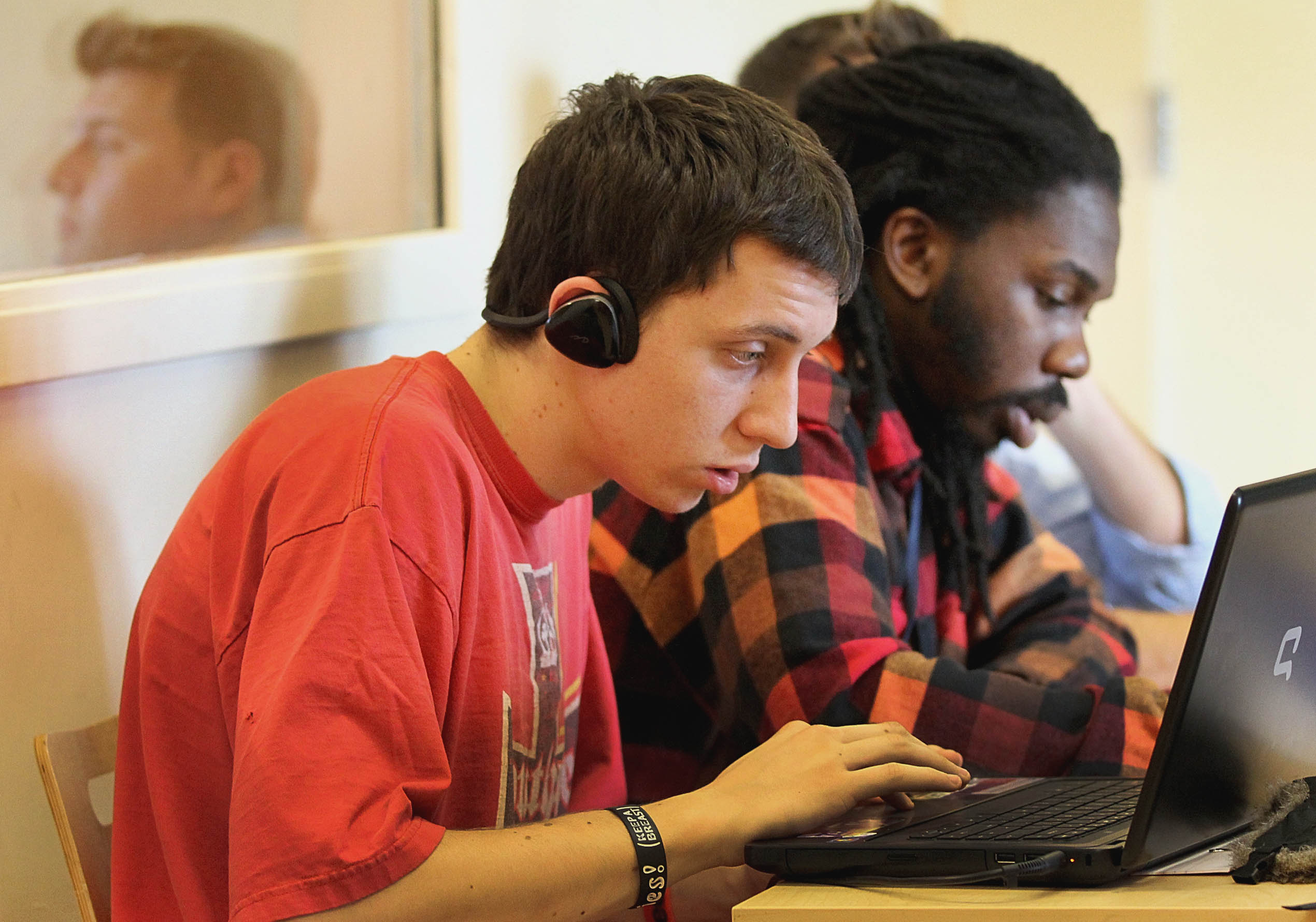 Jesse Leverone, left, attended a debate club meeting in a new classroom at UTEC in Lowell.