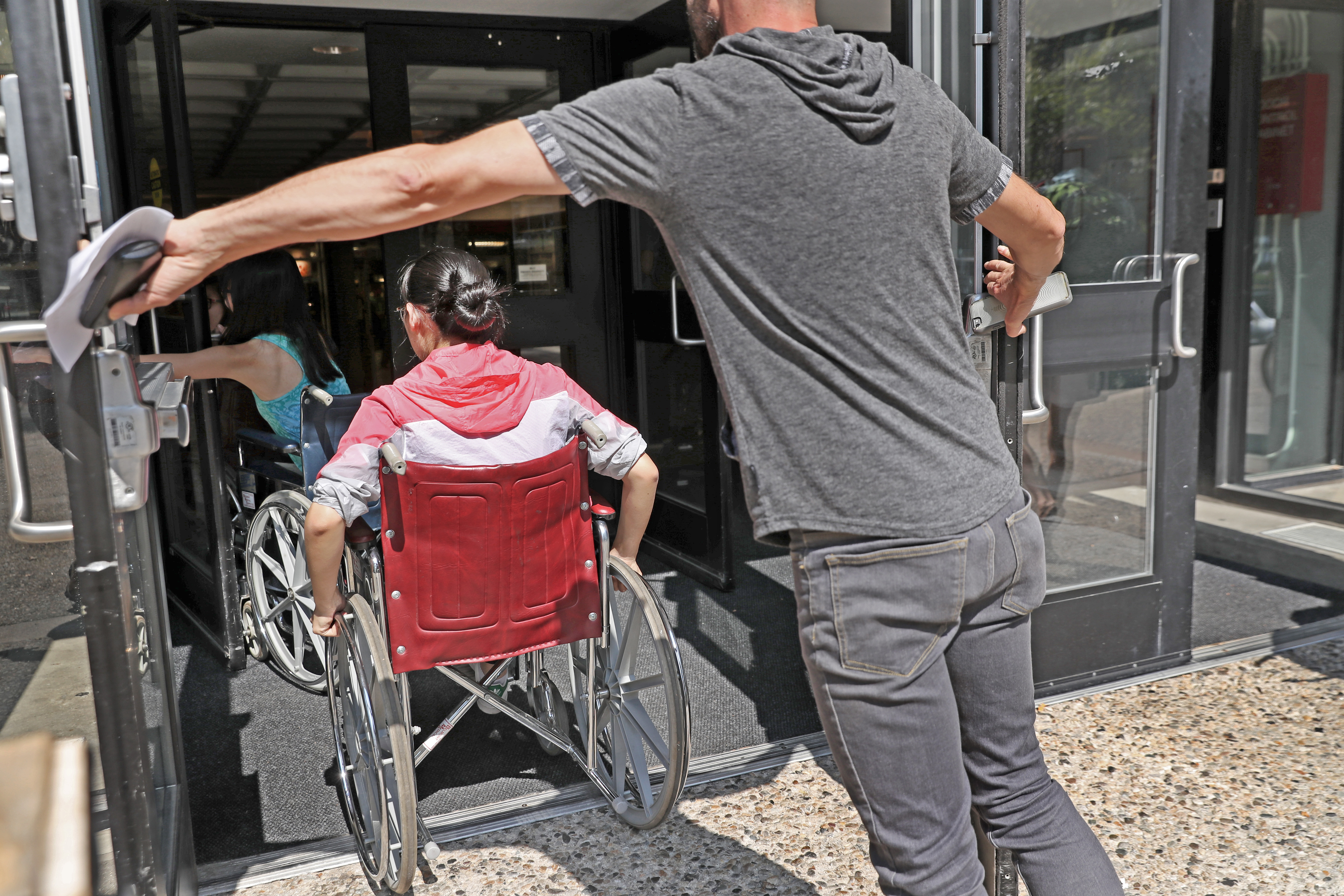 MIT employee Darren Bennett held the door at student center for MIT students in a PPAT class.