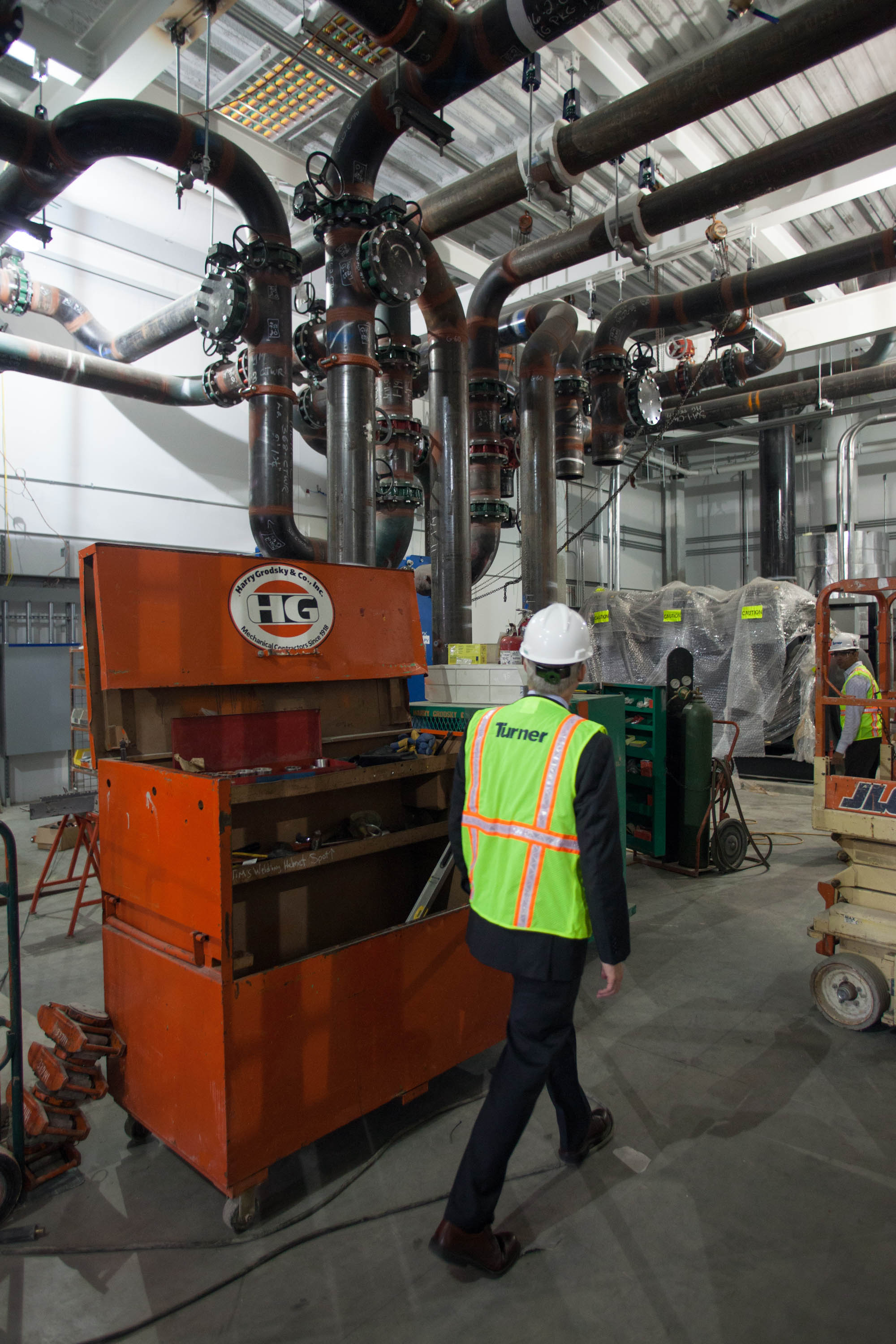 John Goodhue, executive director of the Massachusetts Green High Performance Computing Center, walked past water pipes.