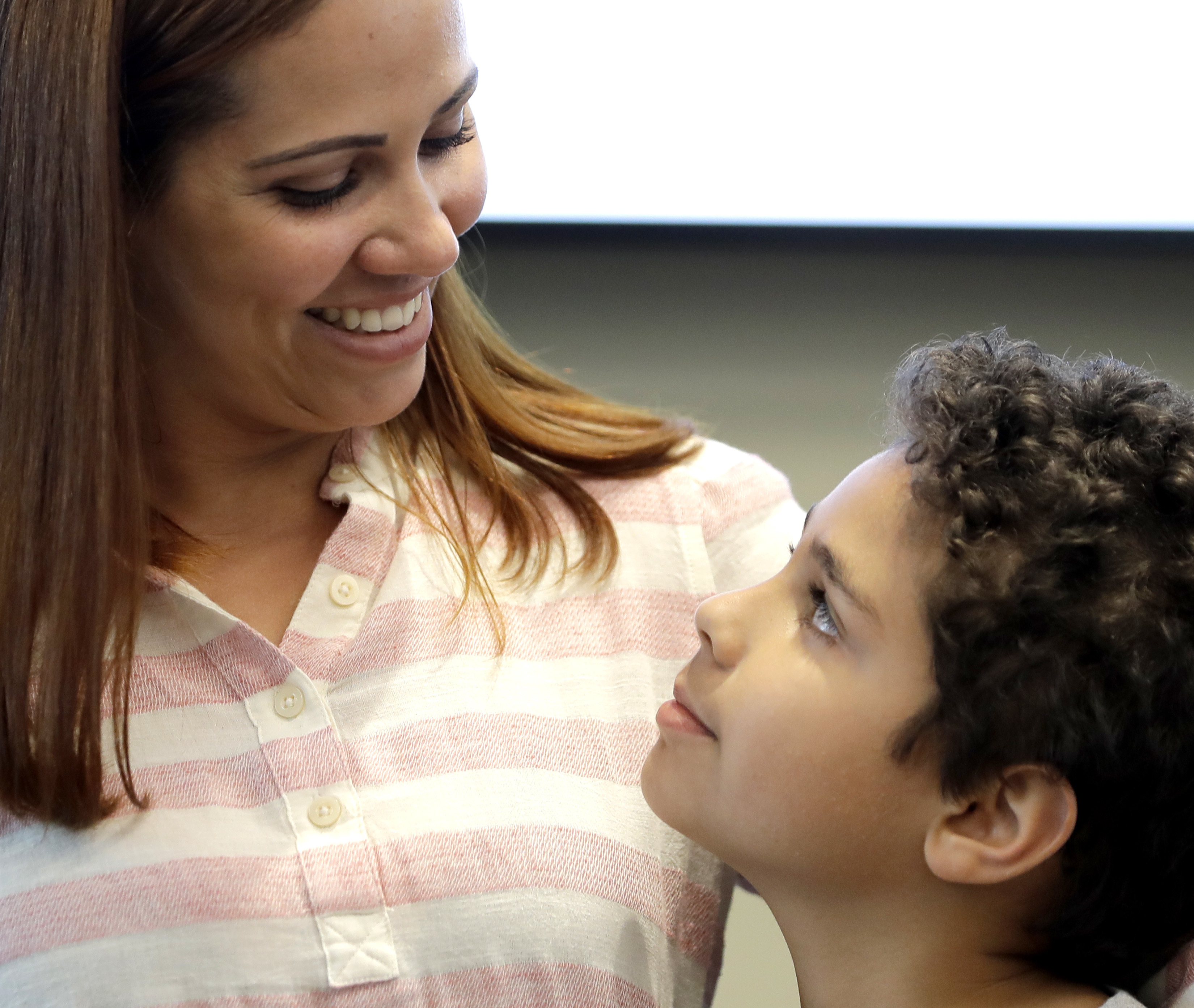 Lidia Karine Souza and her son Diogo De Olivera Filho smile at each other during a news conference shortly after Diogo was reunited with his mother on June 28.